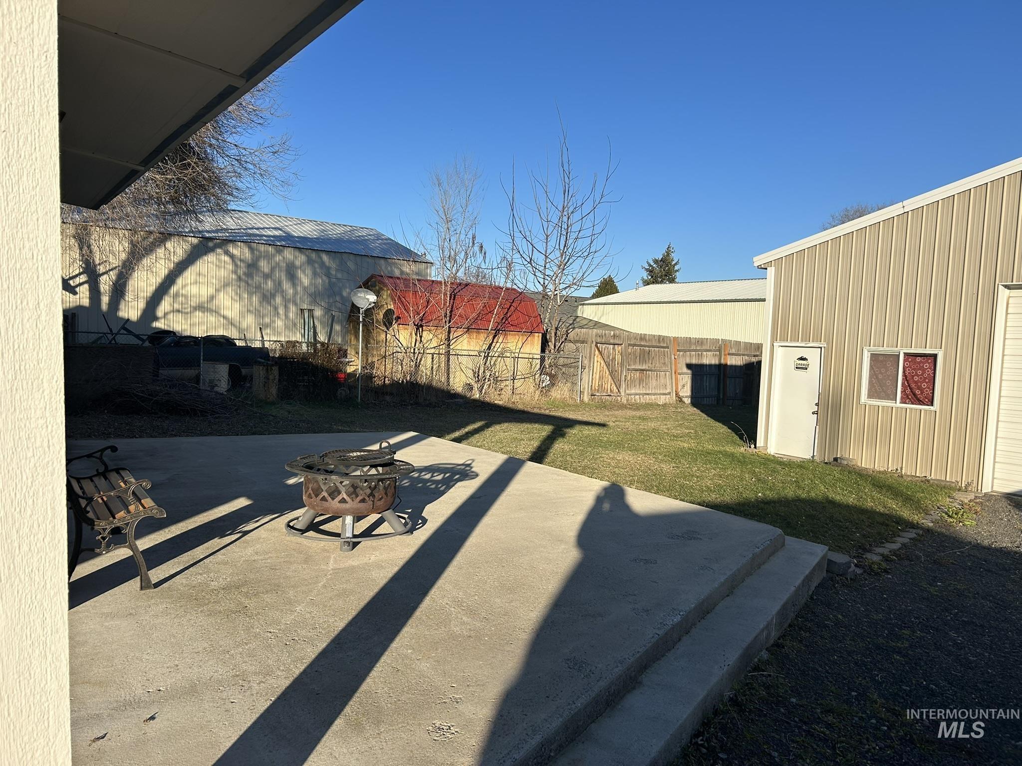 View of yard featuring a patio area and an outdoor fire pit