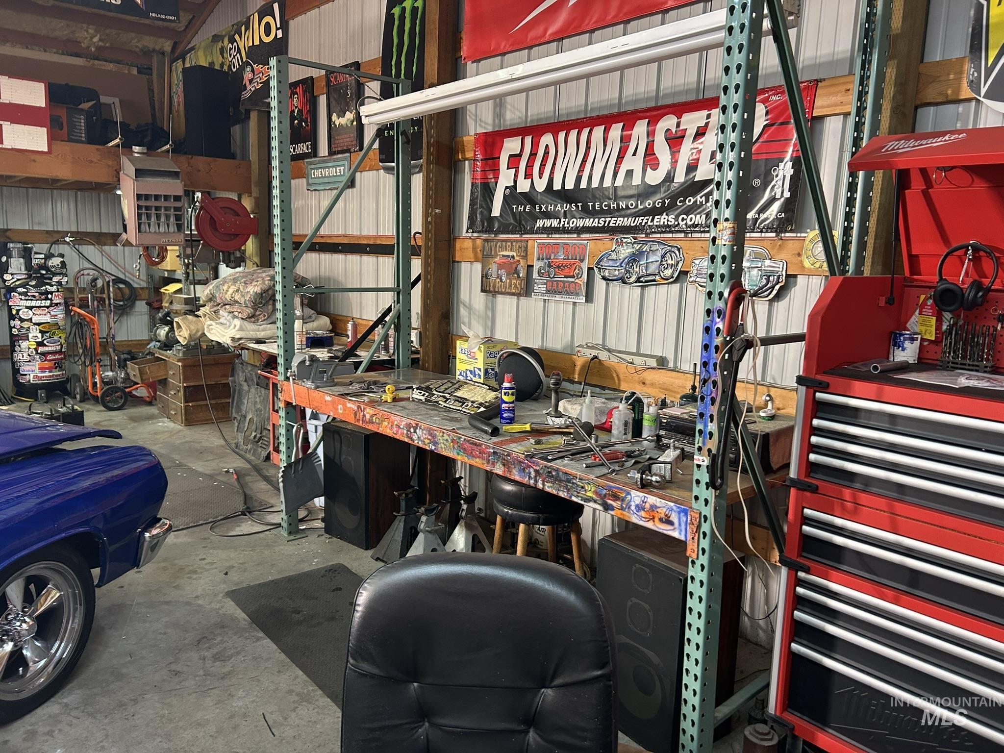 Garage featuring a workshop area and metal wall