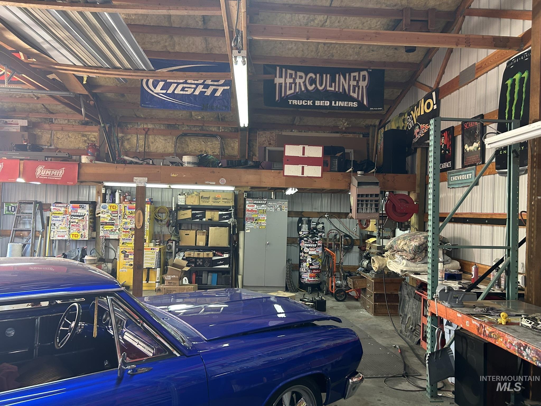 Garage with a workshop area and metal wall