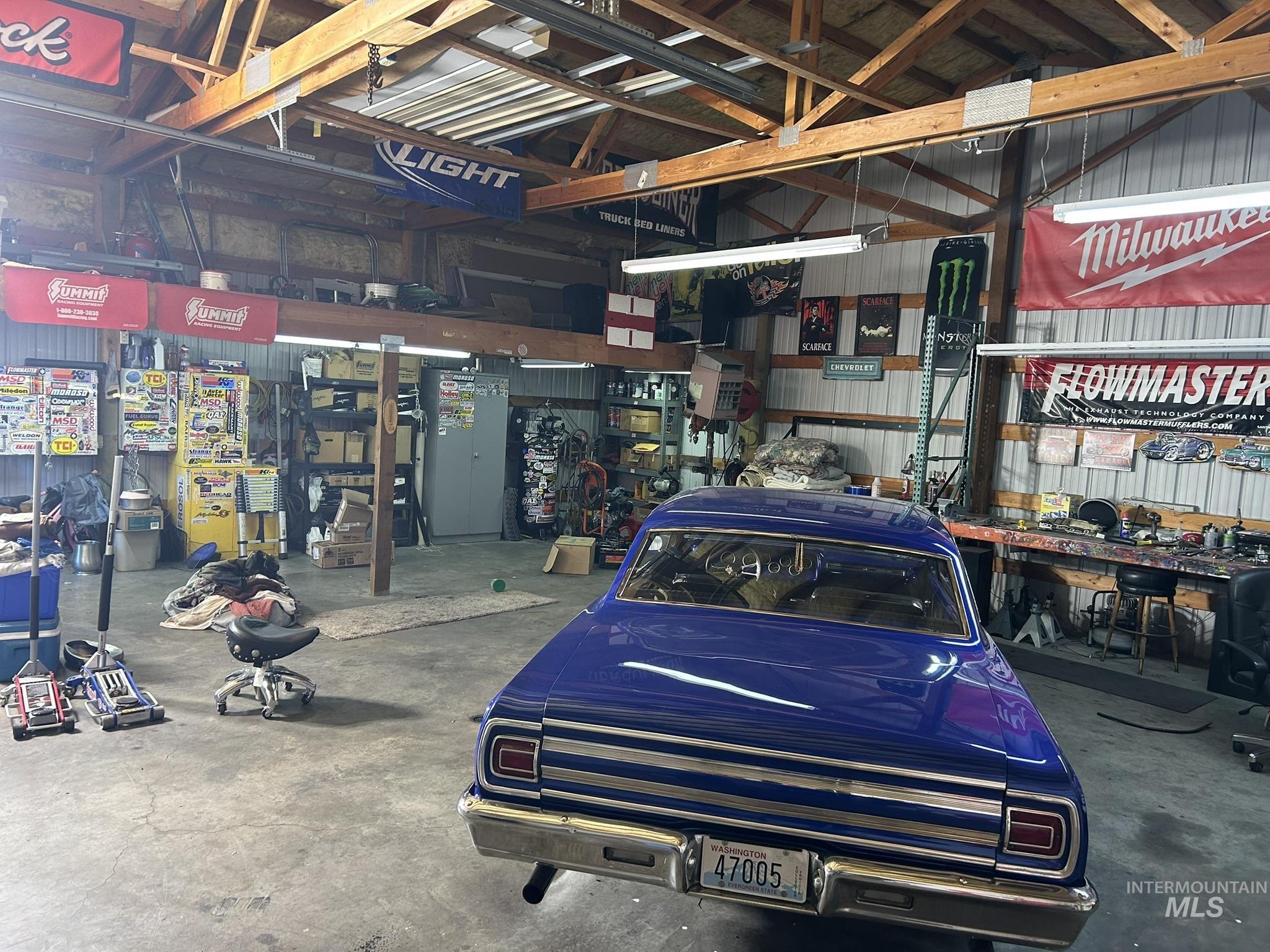 Garage with a workshop area and metal wall