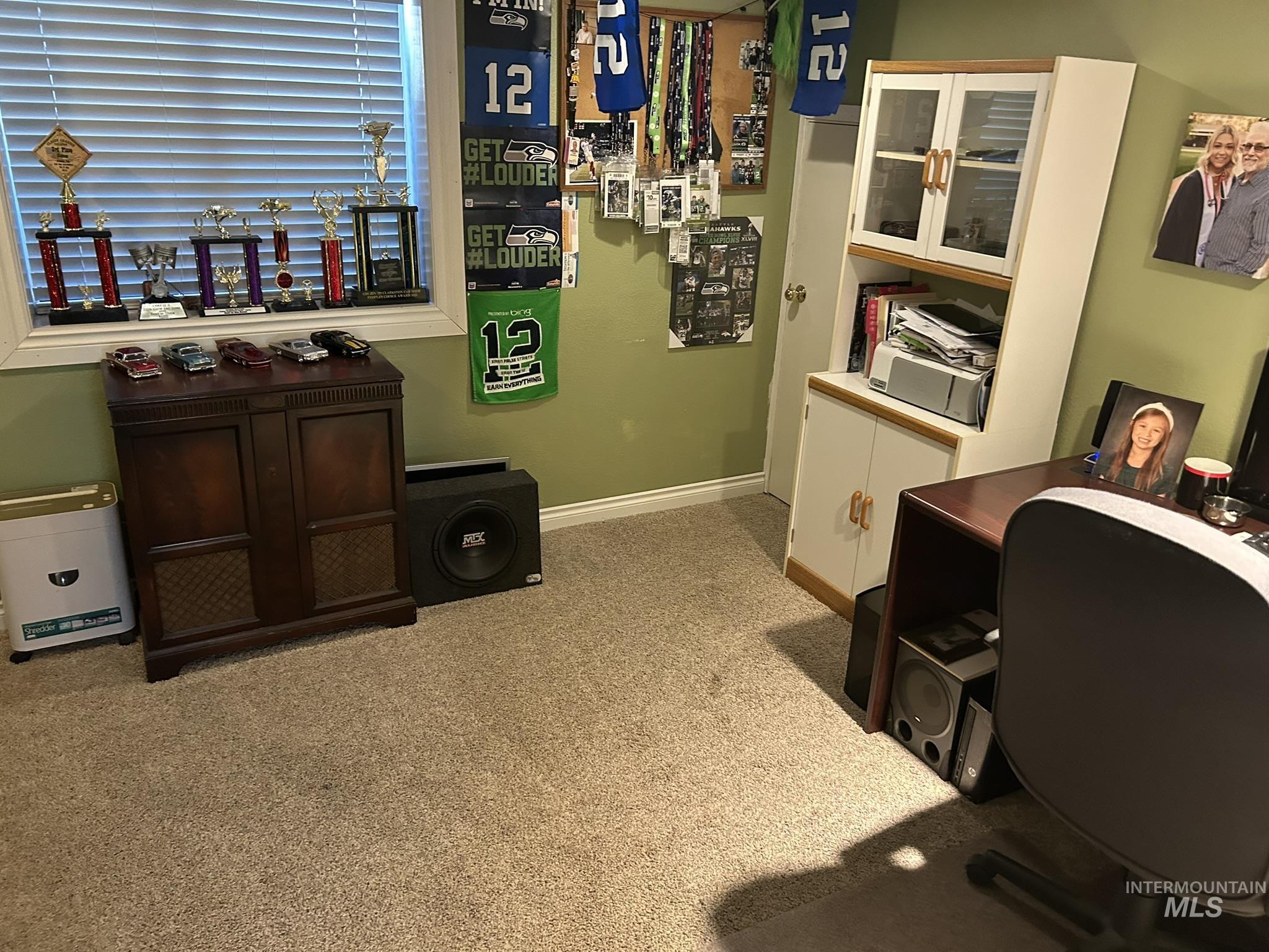 Home office with light colored carpet and baseboards