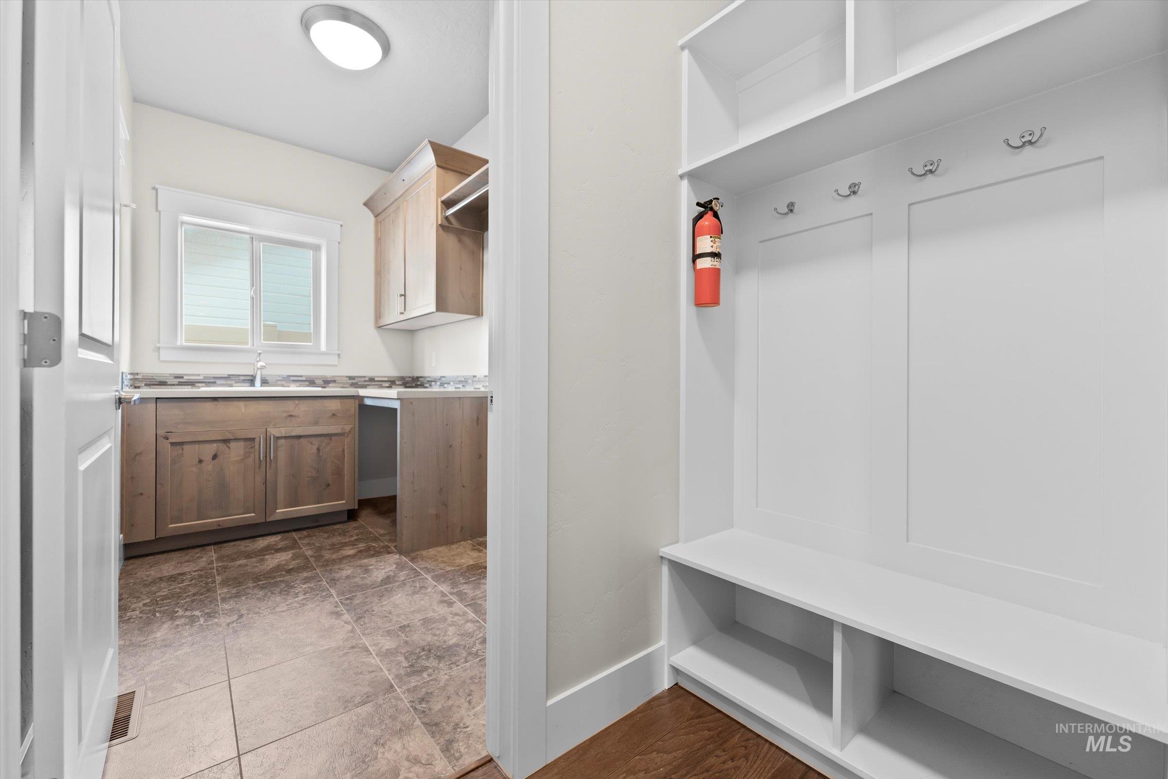Mudroom with baseboards and a sink