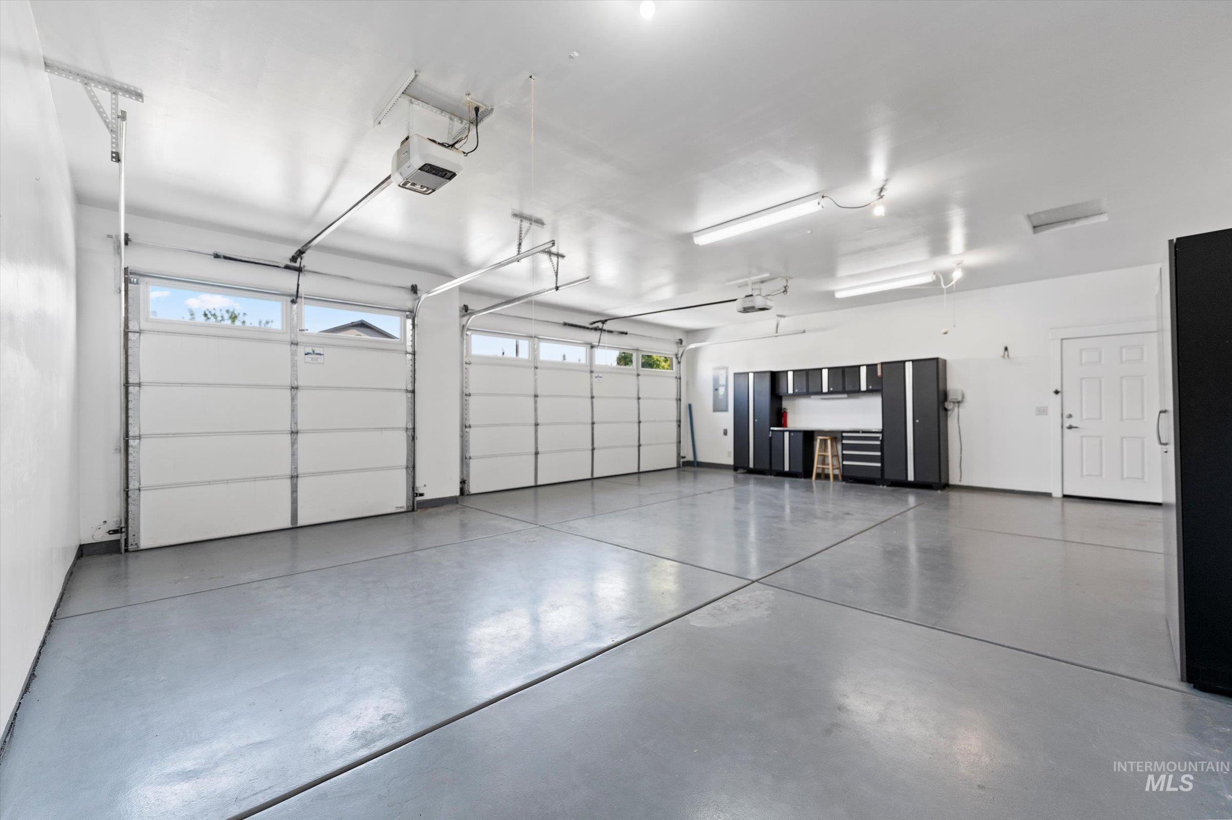 Garage featuring a garage door opener