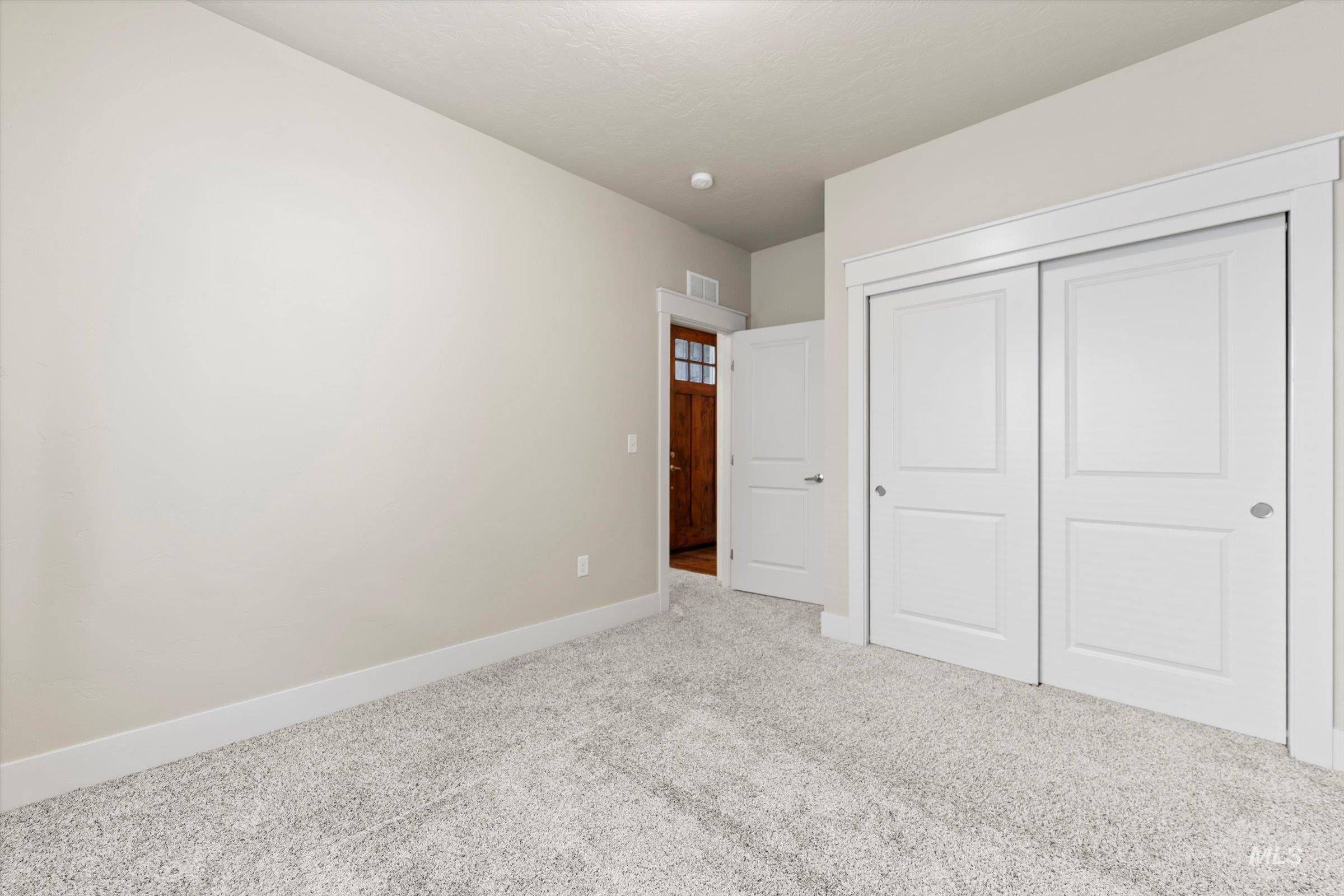 Unfurnished bedroom with carpet floors and a closet