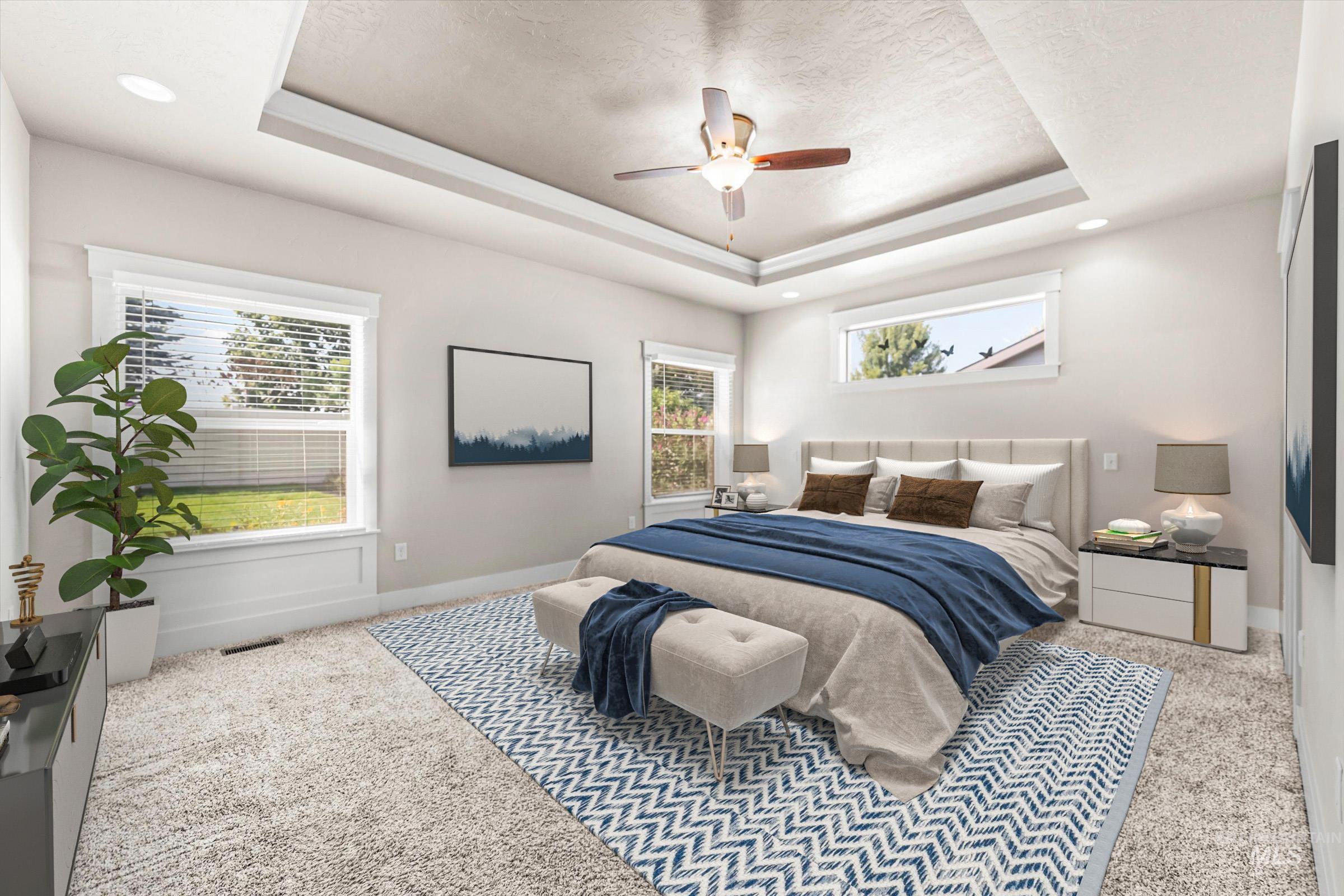 Carpeted bedroom with a raised ceiling and a ceiling fan