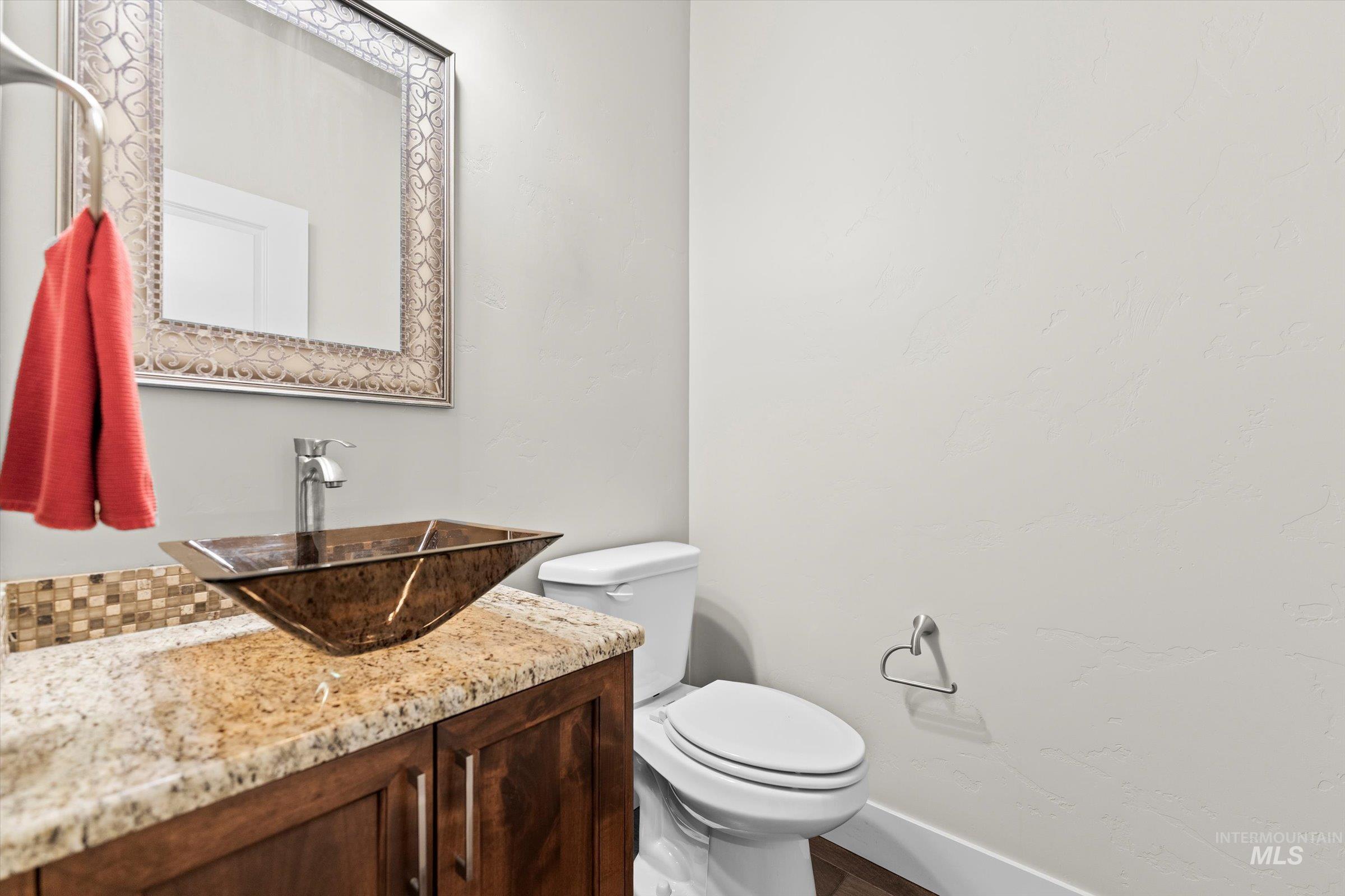 Half bathroom with vanity and toilet