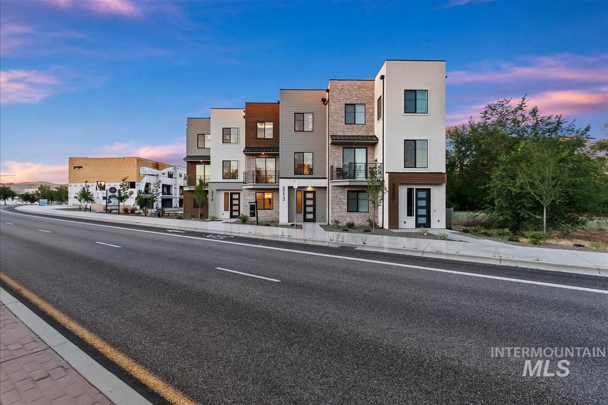 Modern townhouse row featuring varied fa?ade materials including brick, stucco, and wood-finish accents