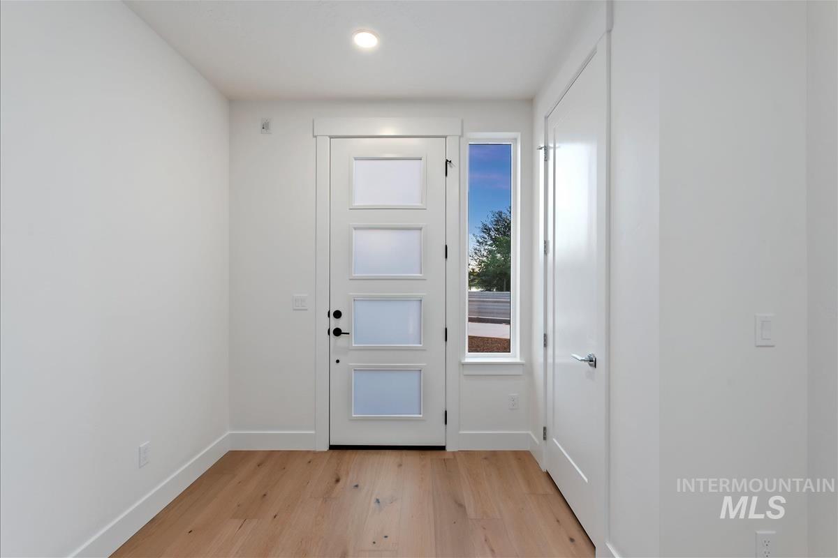 Entryway featuring light wood-finish flooring, white walls, and a recessed ceiling light