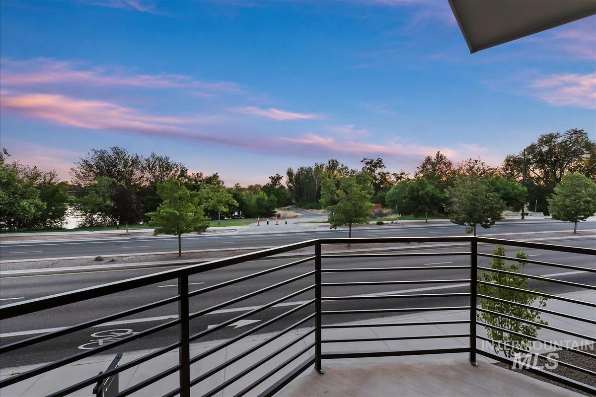 Balcony featuring contemporary black metal railing and concrete flooring