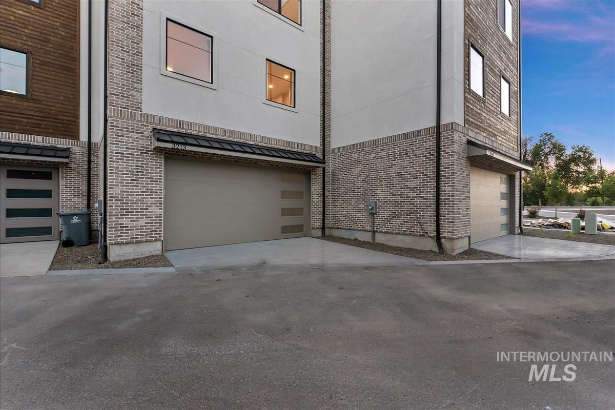 Contemporary exterior featuring light-toned brick and horizontal wood paneling