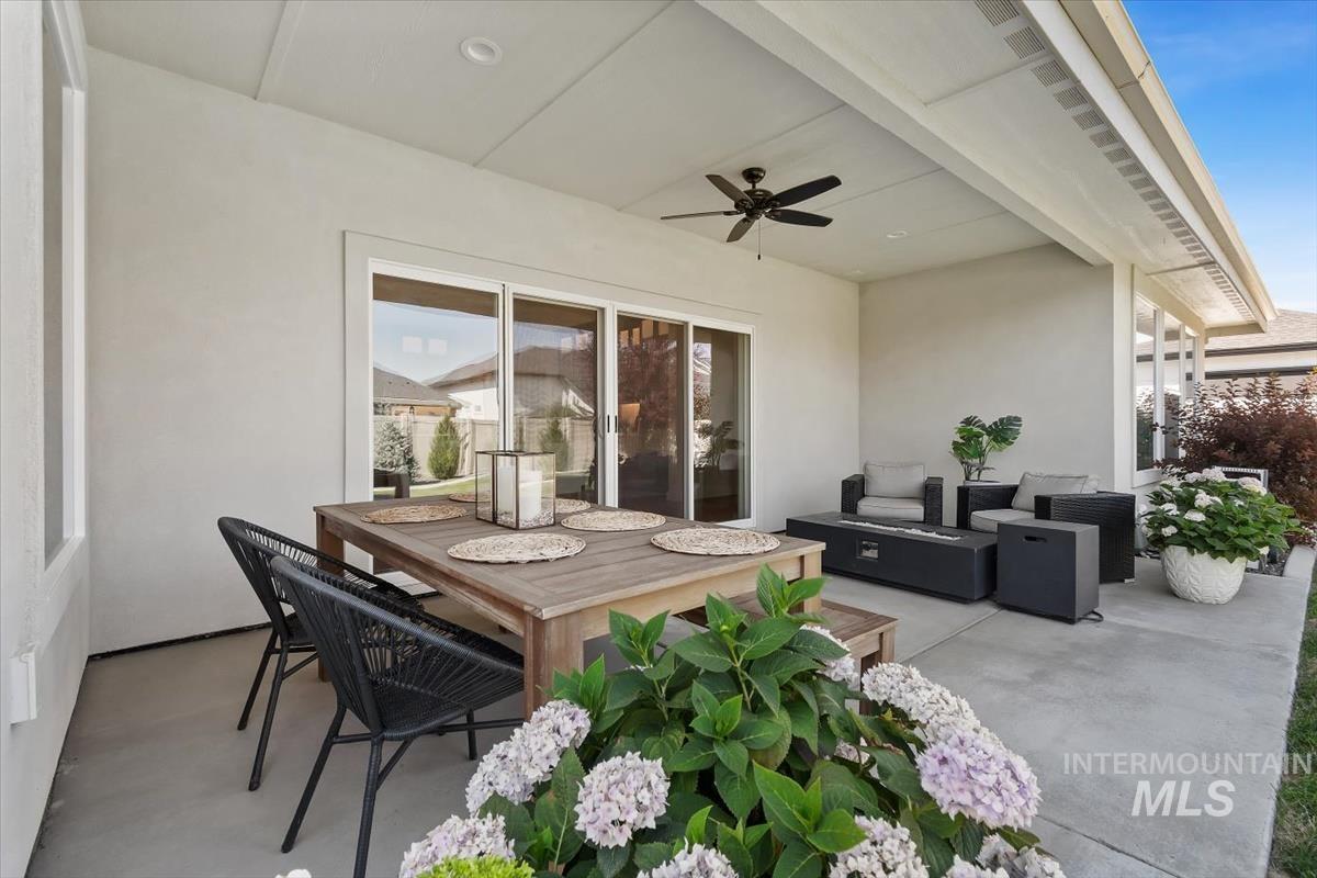 Covered concrete patio featuring recessed lighting and a ceiling fan