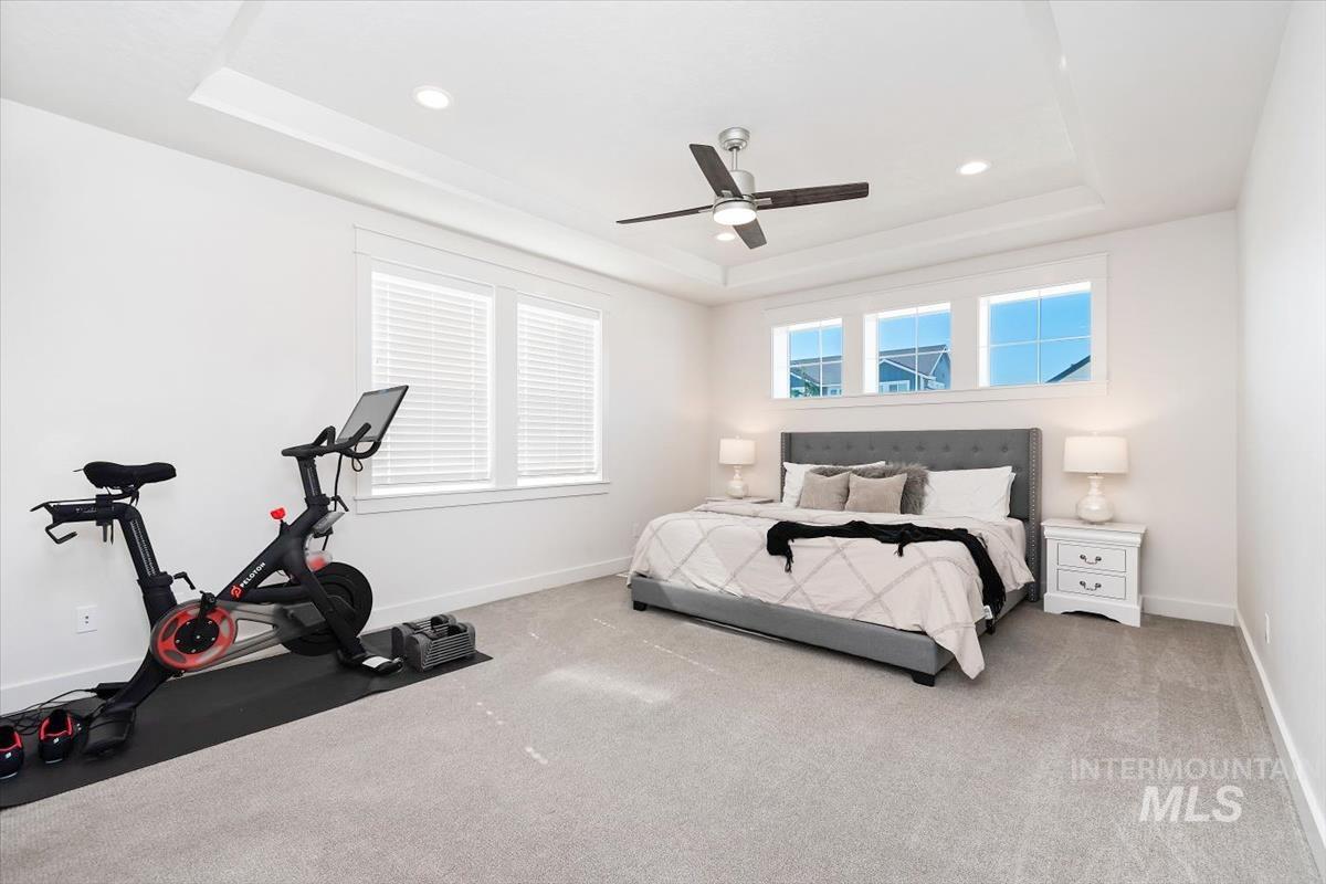 Spacious room featuring light gray carpeting and white walls