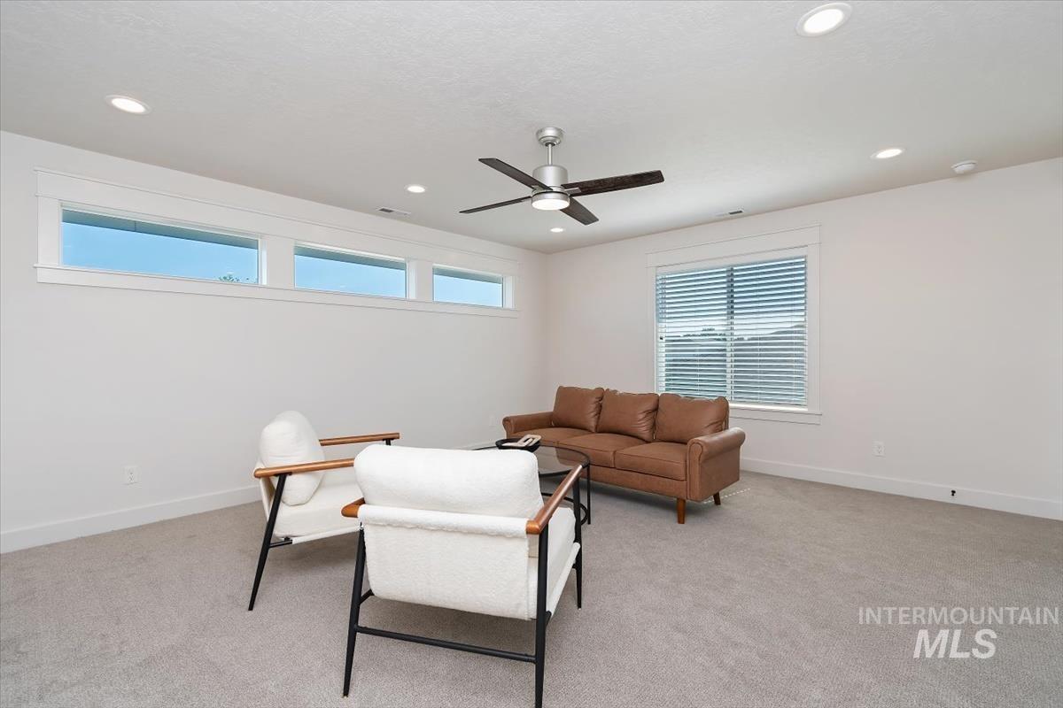 Spacious room featuring light gray carpeting and white walls