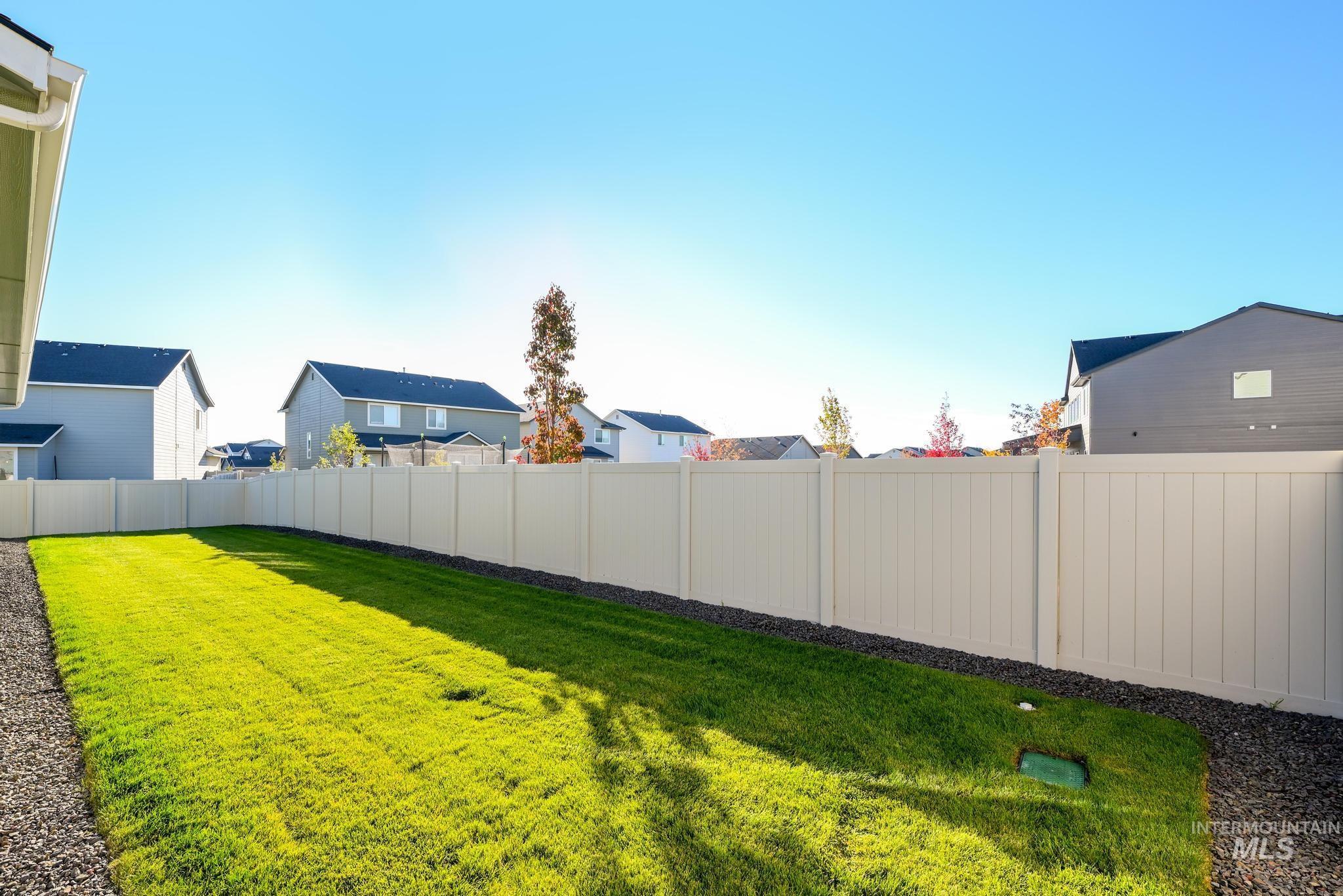 Fenced backyard with a residential view