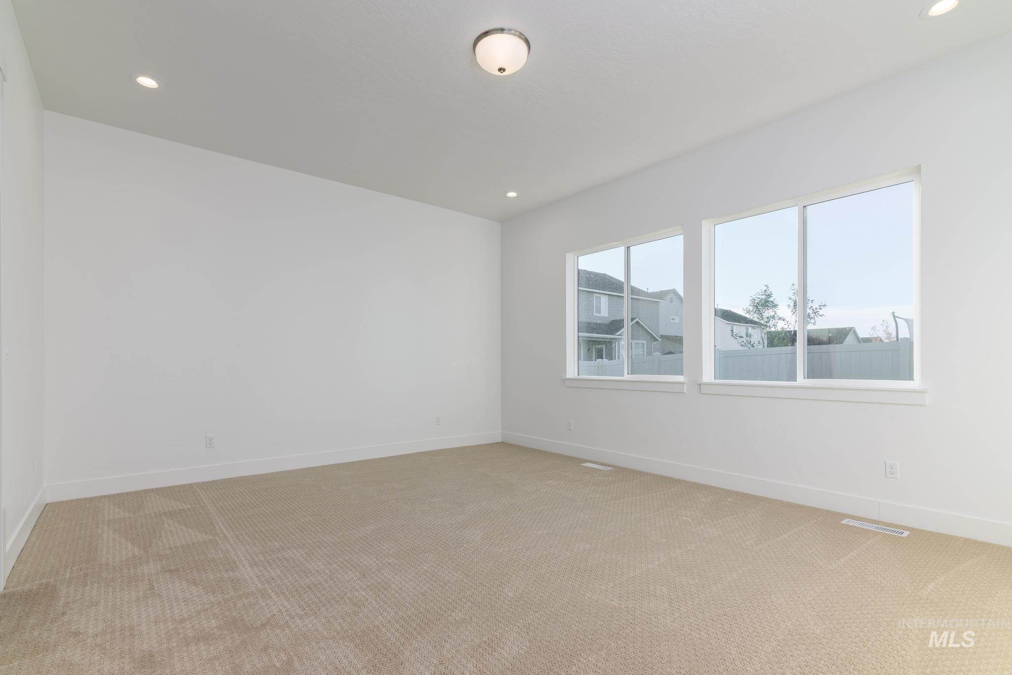 Unfurnished room featuring recessed lighting and light colored carpet
