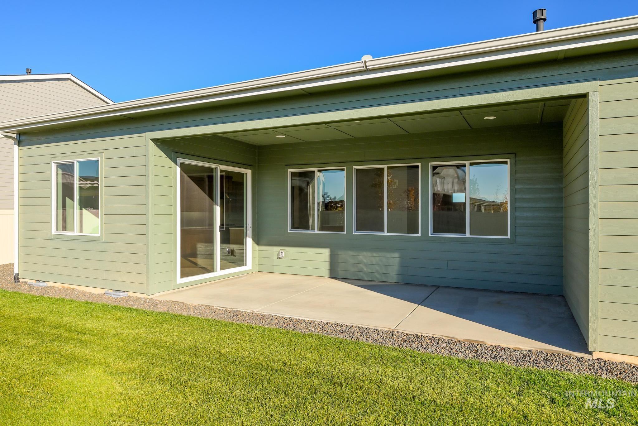 Back of property with a patio area and a yard