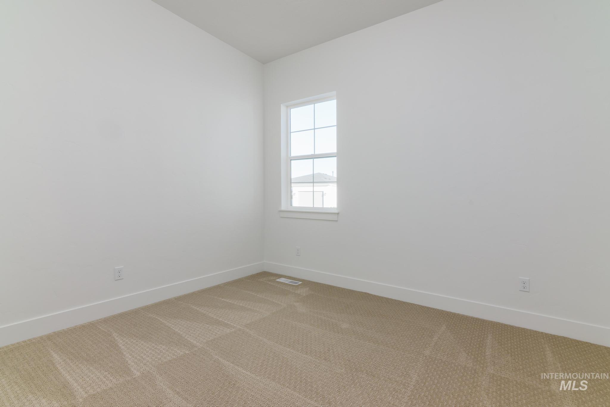Unfurnished room with carpet floors and baseboards
