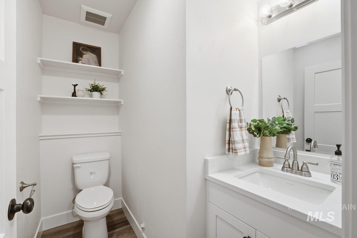 Bathroom featuring vanity and dark wood-style flooring