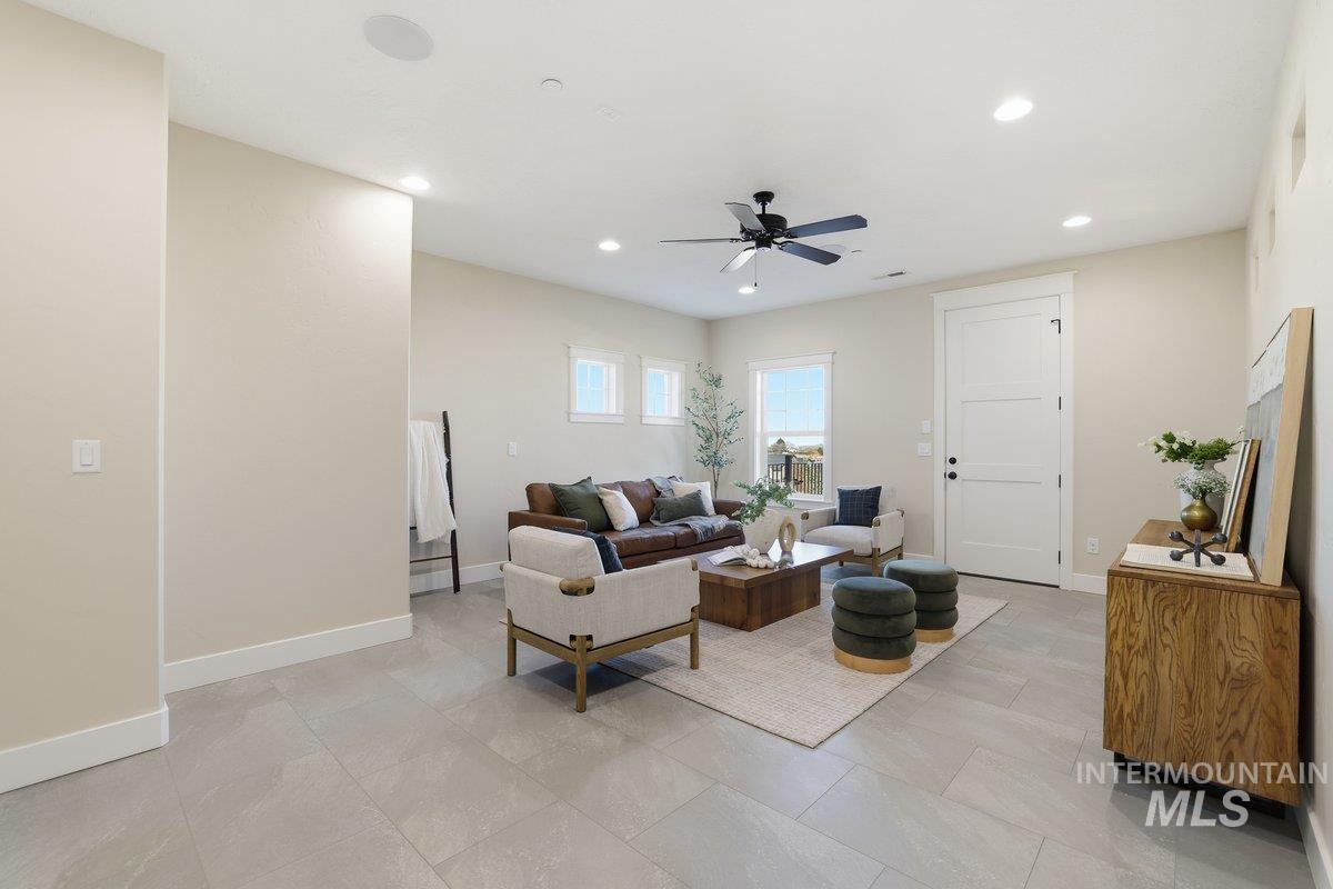 Living area featuring recessed lighting and a ceiling fan