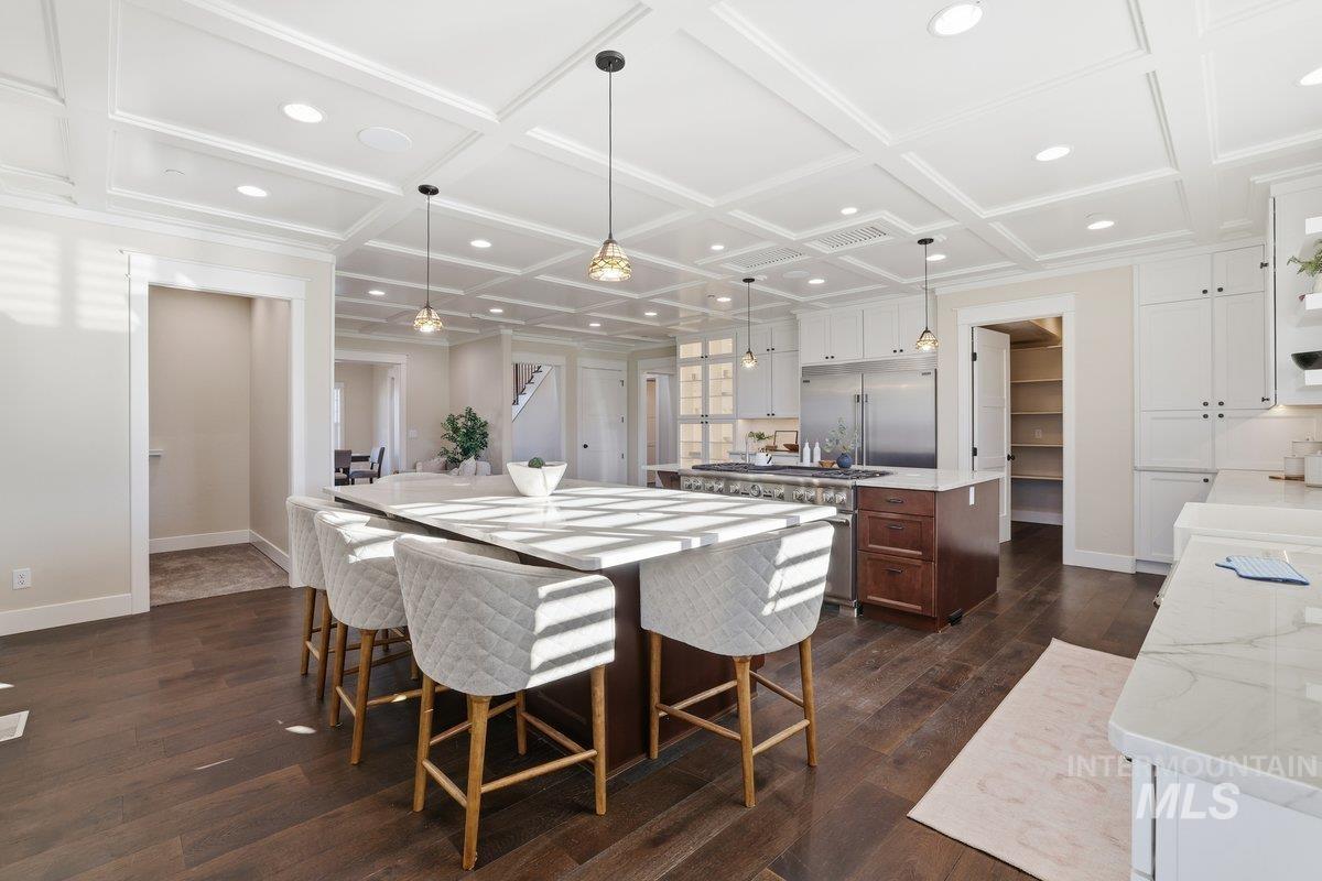 Dining area featuring dark wood-type flooring, recessed lighting, coffered ceiling, and beam ceiling