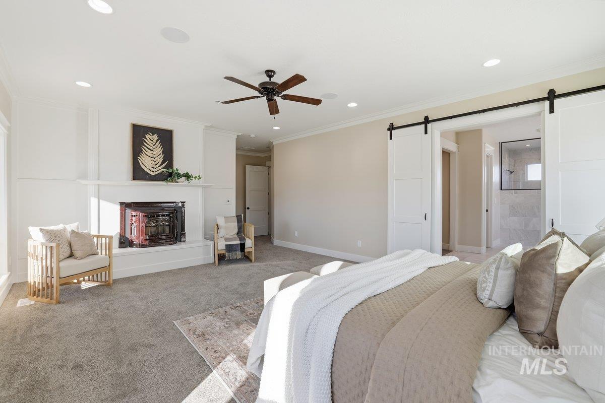 Bedroom featuring carpet, a ceiling fan, crown molding, a barn door, and recessed lighting