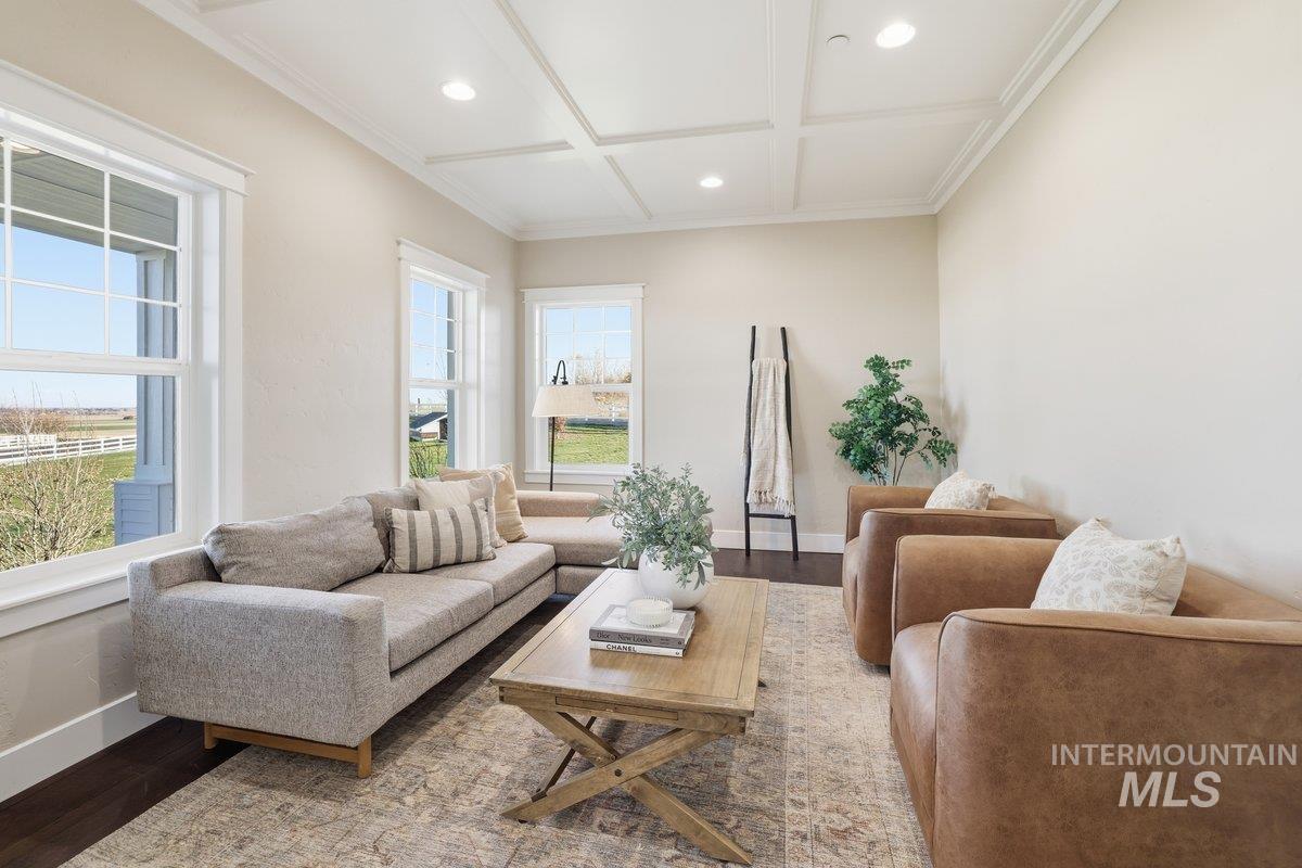 Living room with wood finished floors, recessed lighting, coffered ceiling, and beamed ceiling