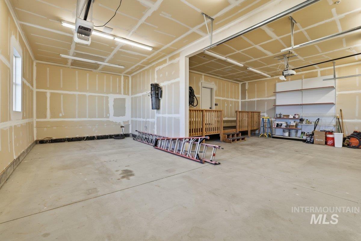 Garage featuring a central vacuum unit and a garage door opener