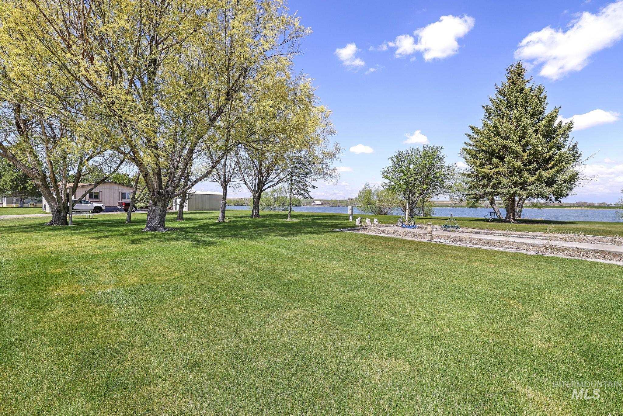 View of grassy yard with a water view