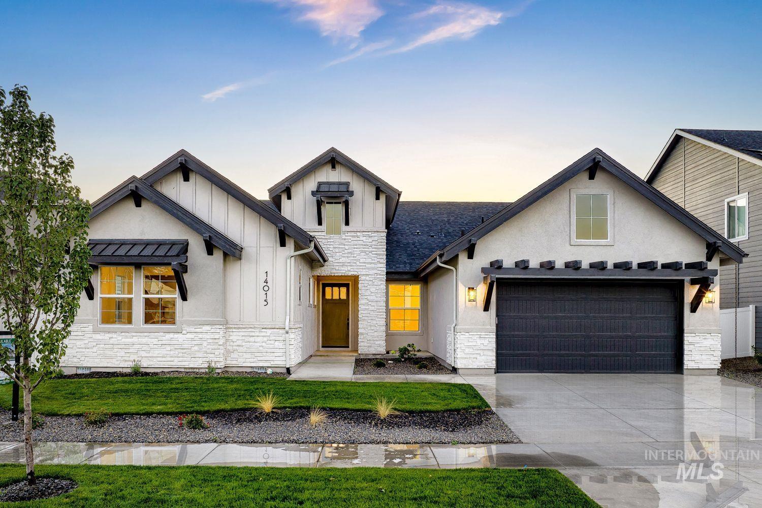 Modern farmhouse exterior featuring dark trim, white siding, and stone accents