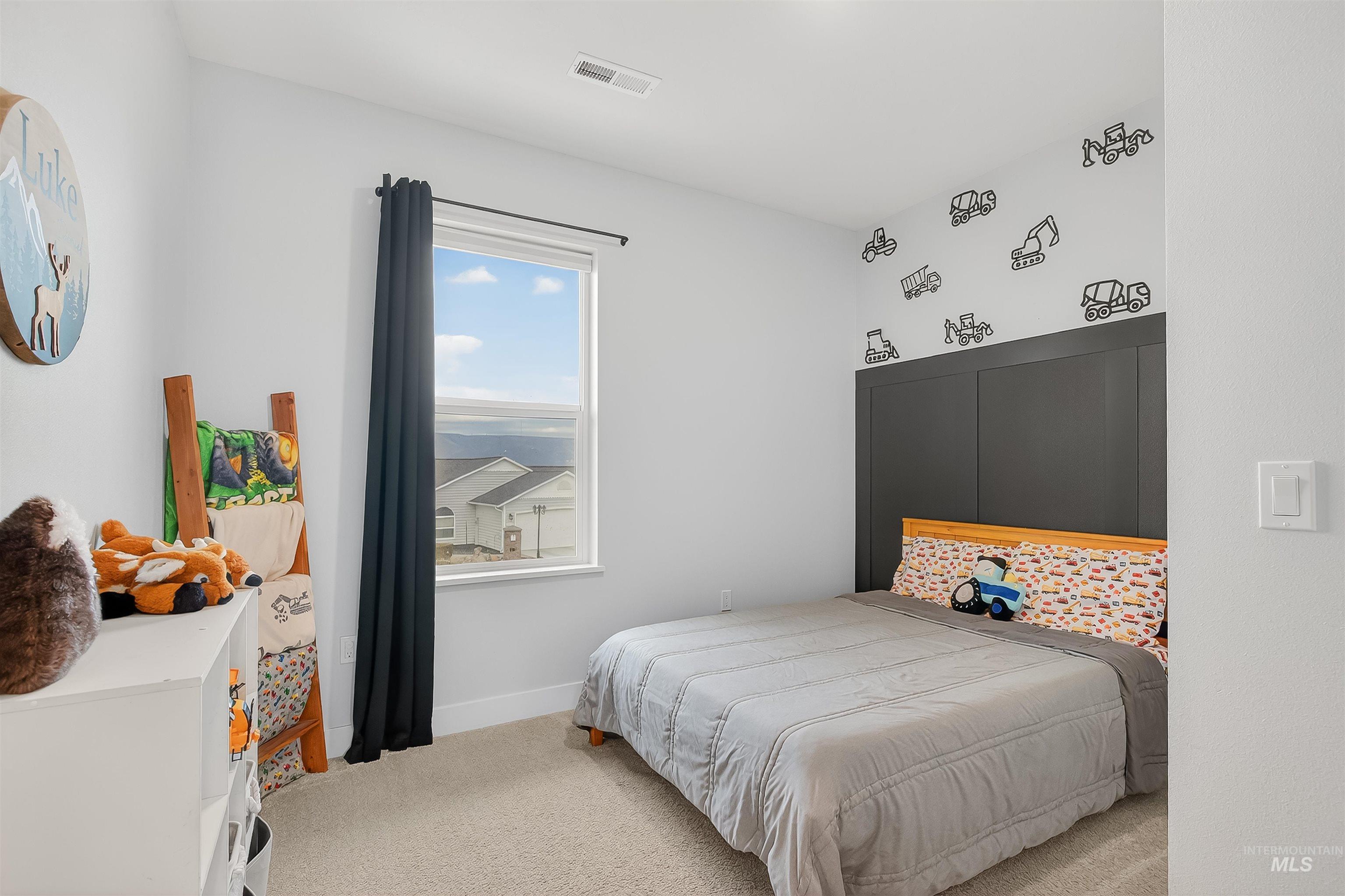 Carpeted bedroom with baseboards