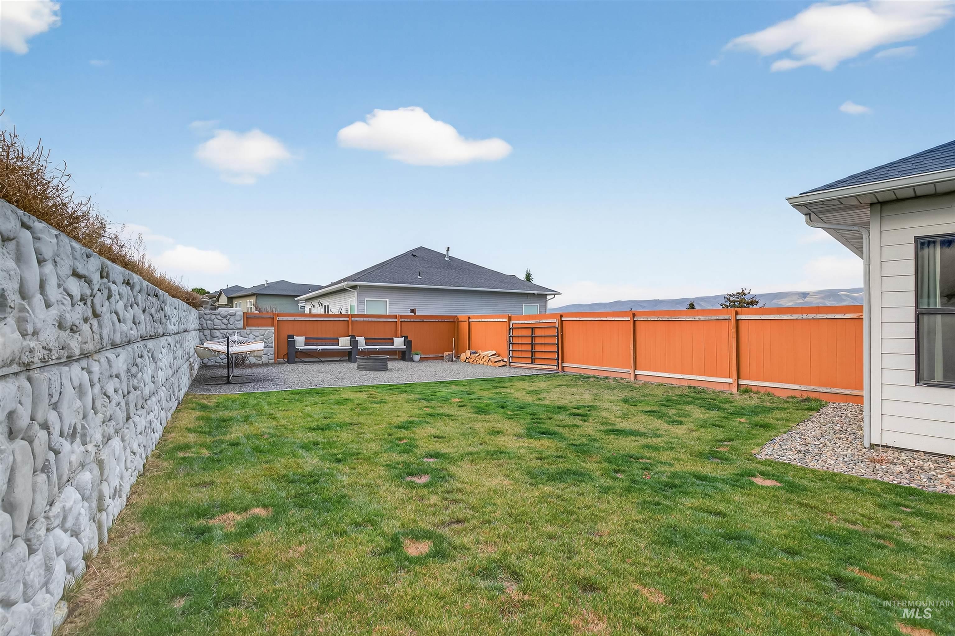 Fenced backyard featuring a patio and outdoor lounge area