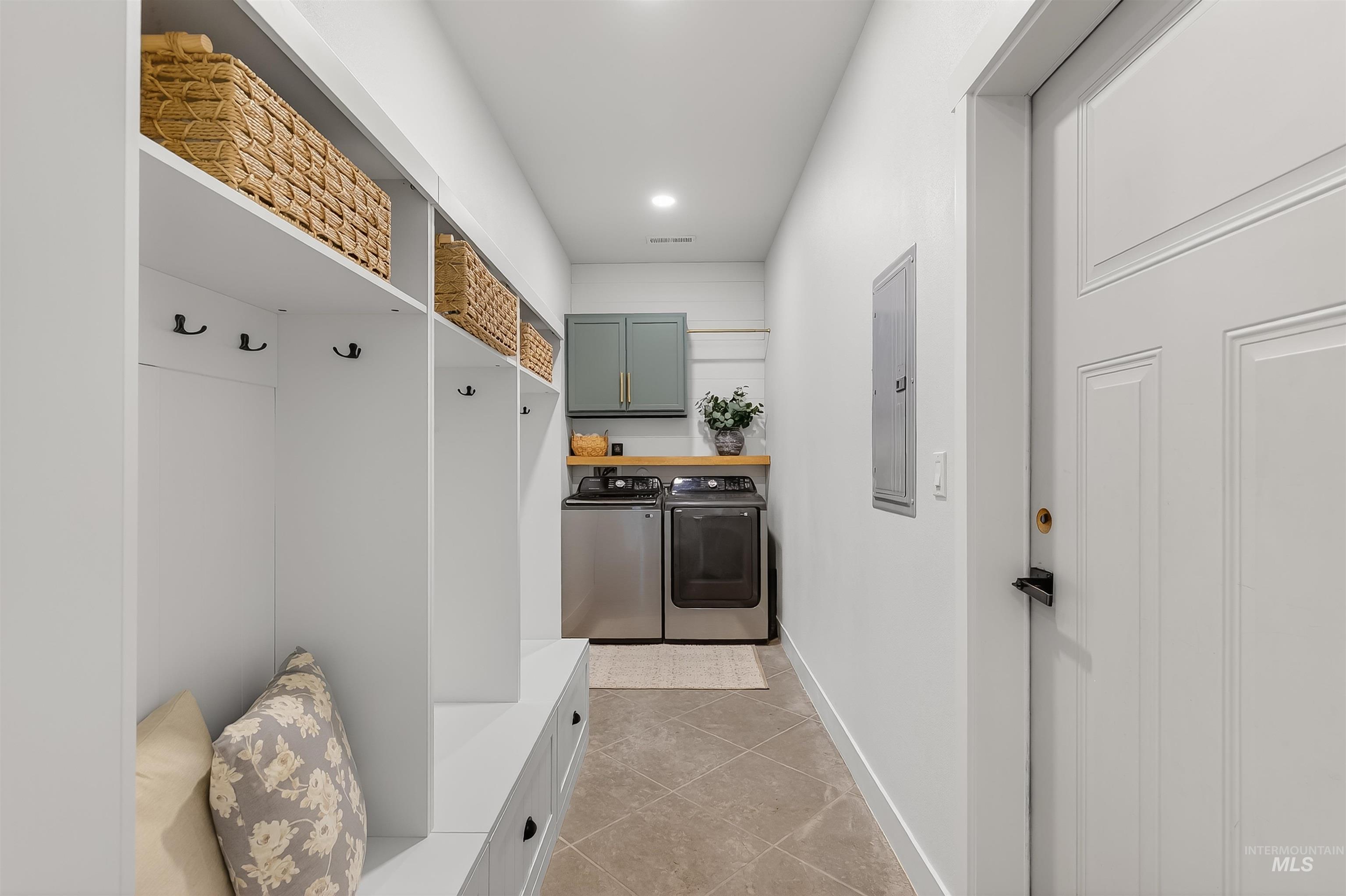 Mudroom with washer and clothes dryer, electric panel, and recessed lighting