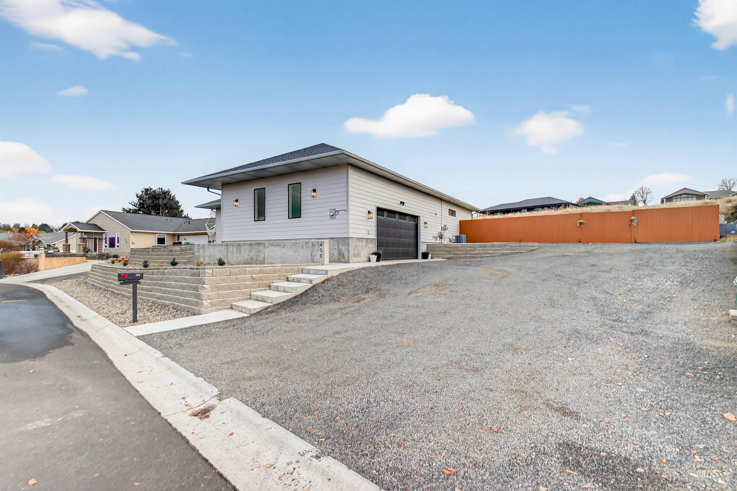 View of front of house featuring an attached garage and driveway