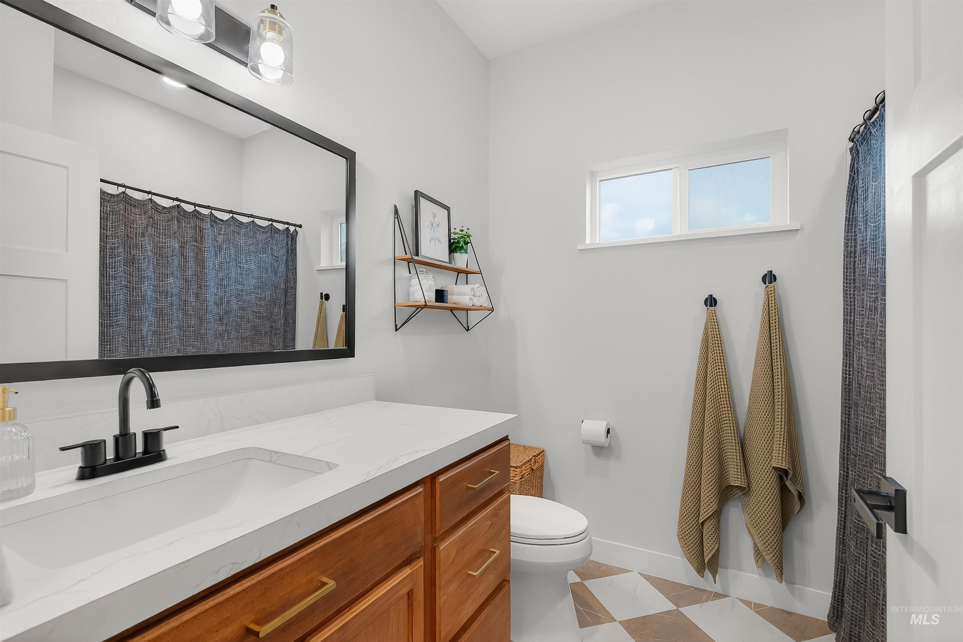 Bathroom featuring vanity and curtained shower