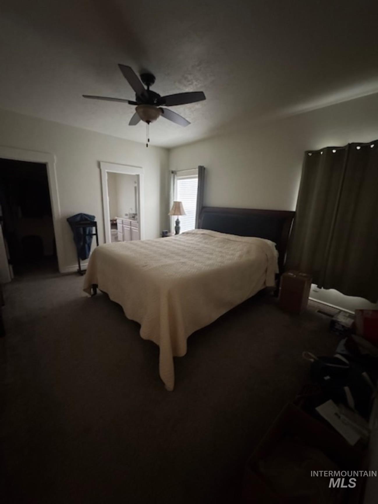 Bedroom with carpet flooring, connected bathroom, and ceiling fan