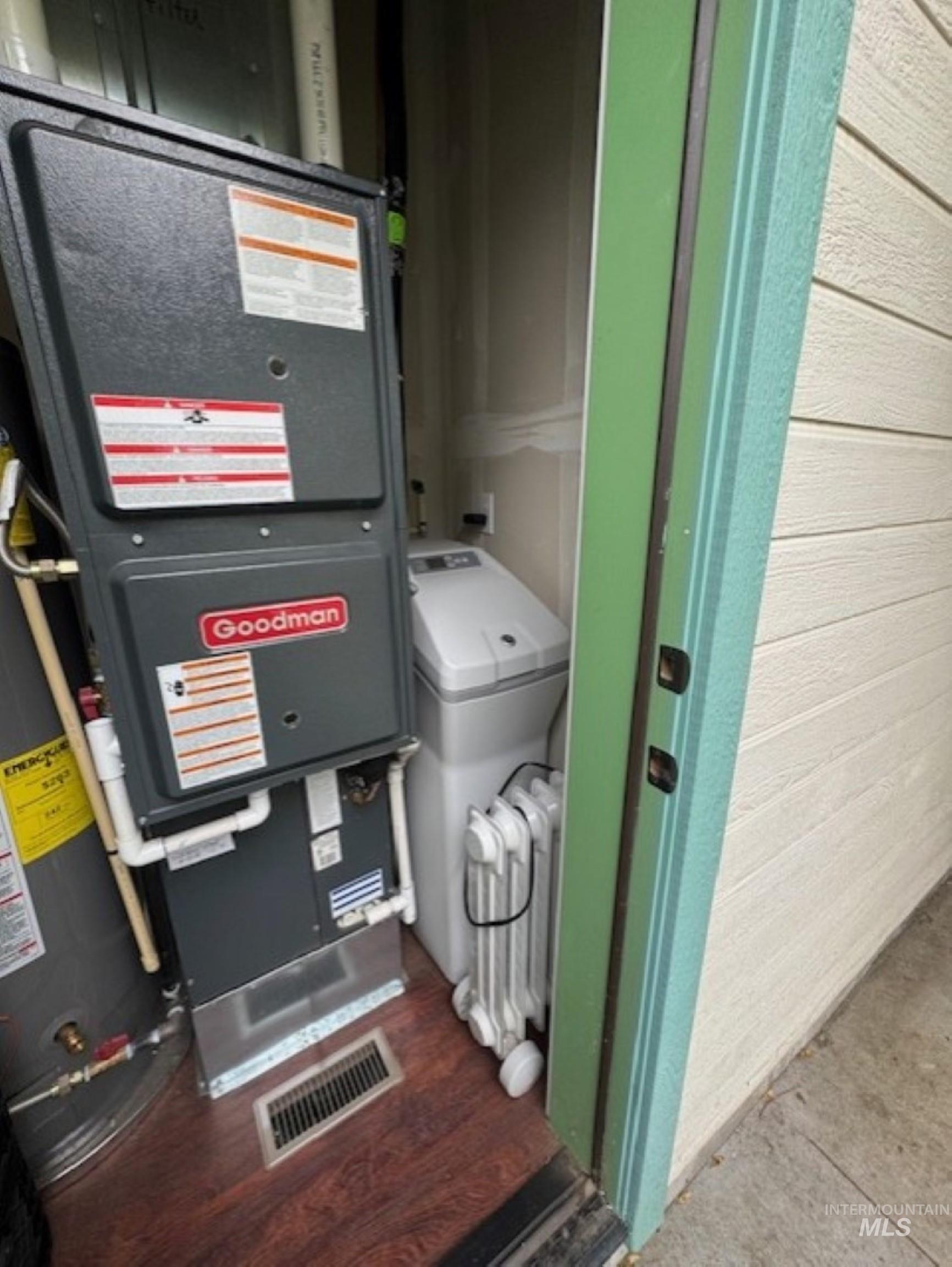 Utilities featuring heating unit and gas water heater