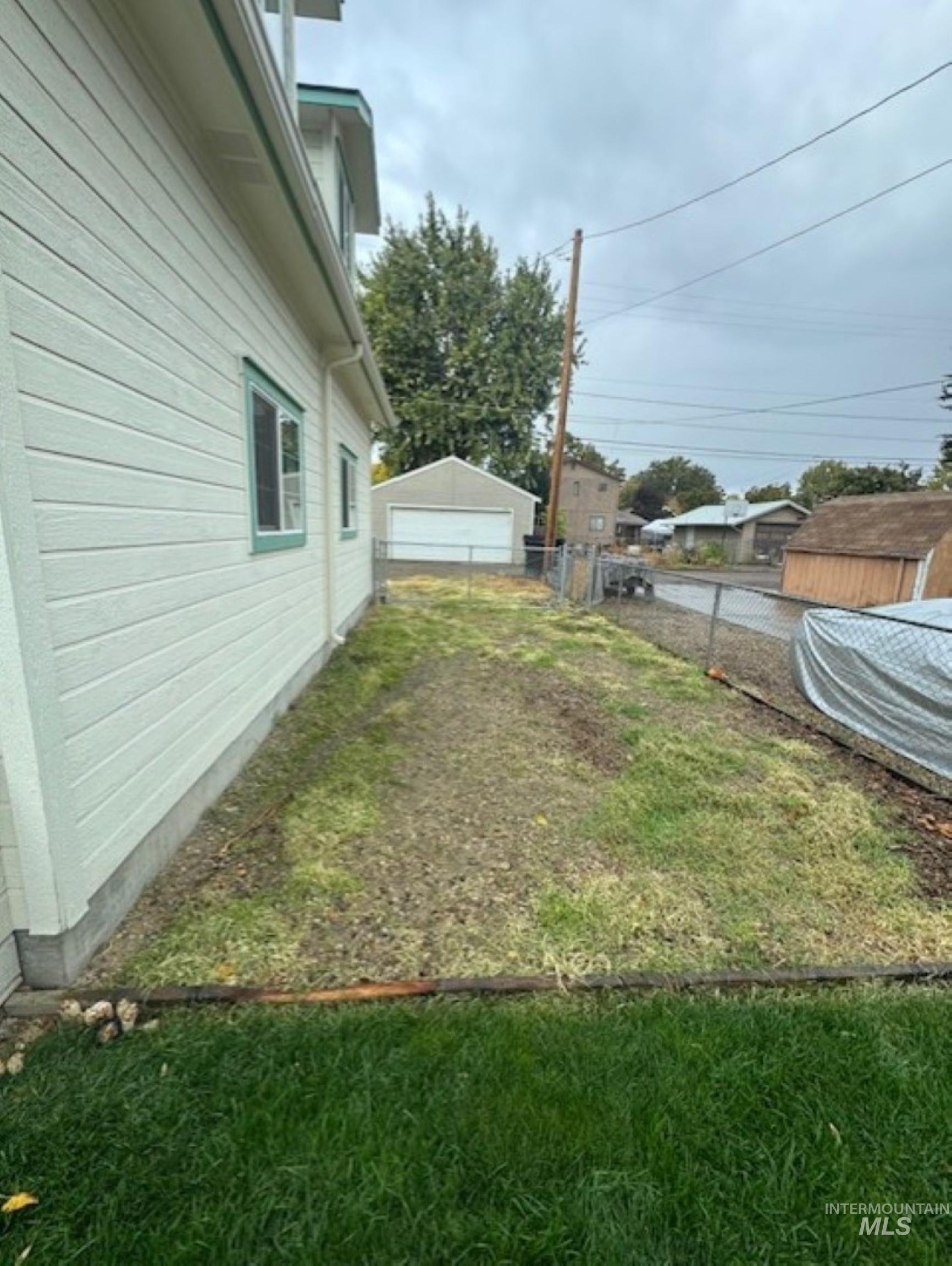 View of yard featuring an outdoor structure and a detached garage