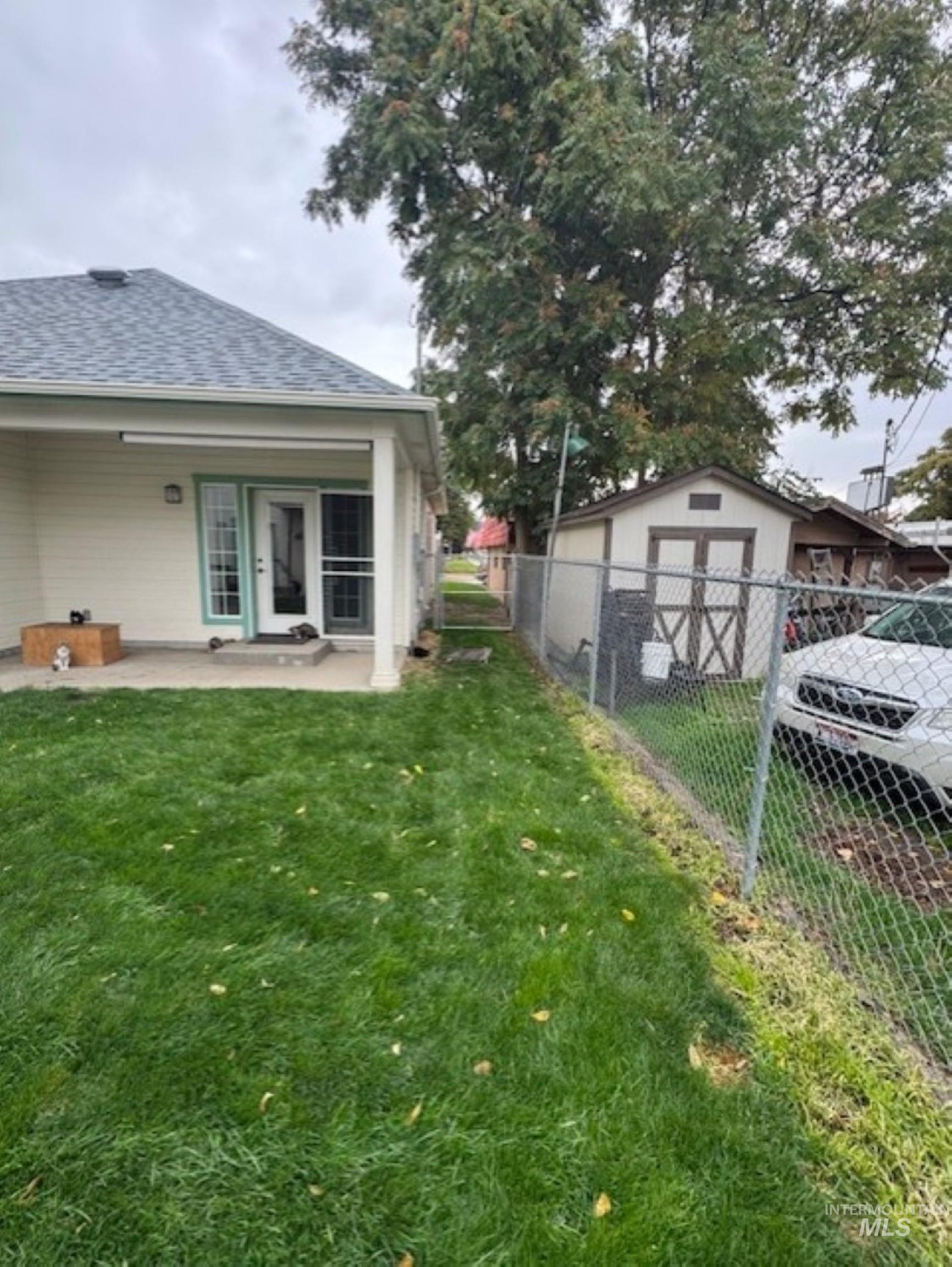View of yard with a patio and an outbuilding