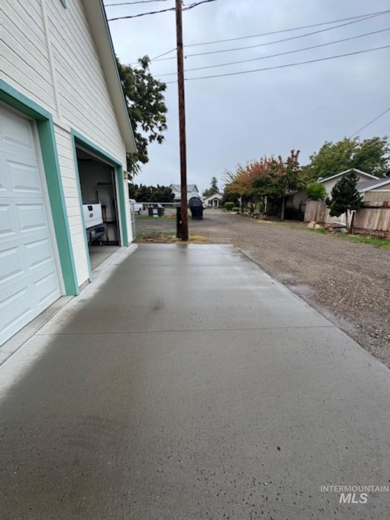 View of yard with a garage and driveway