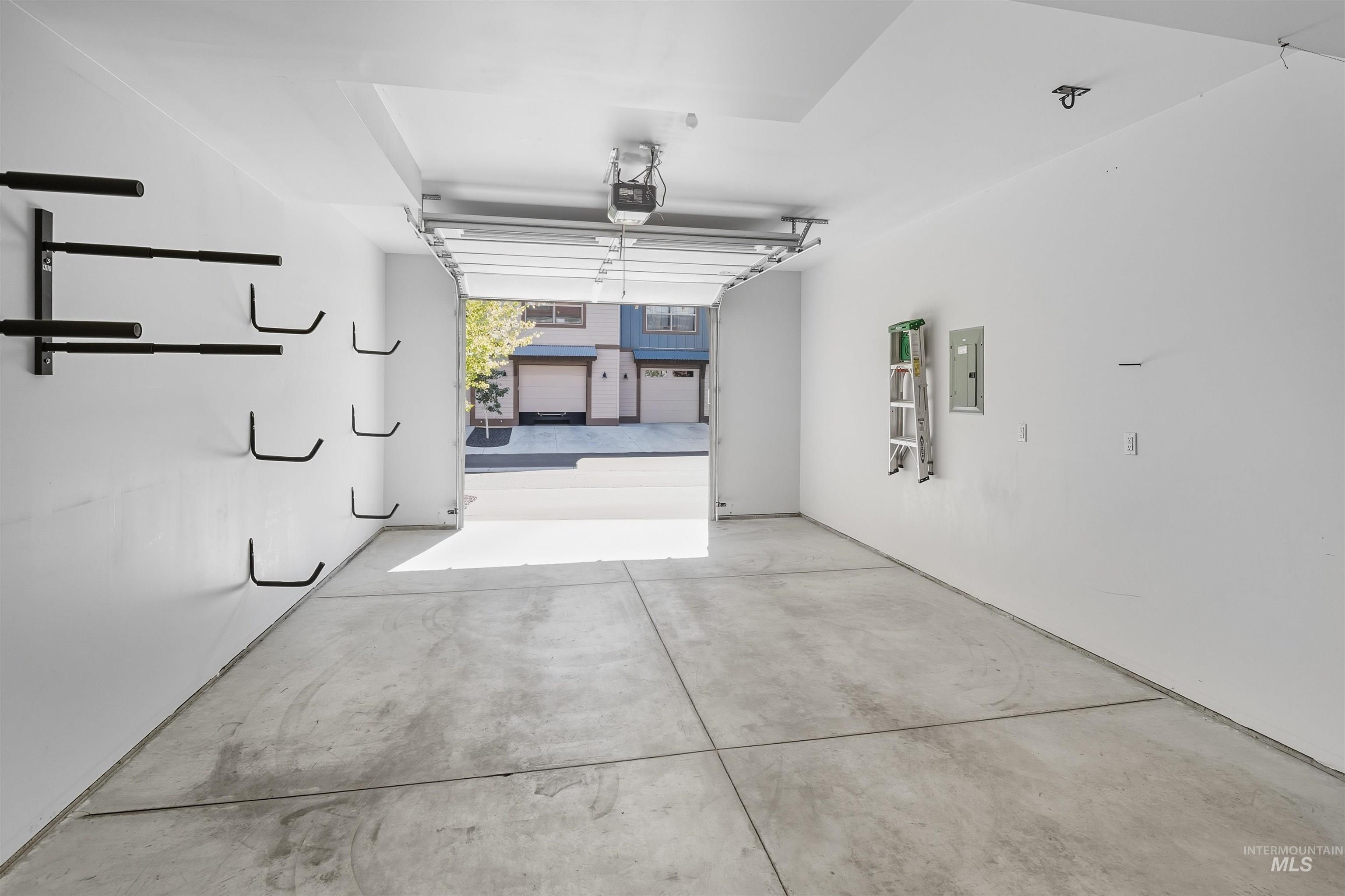 Garage with electric panel and a garage door opener