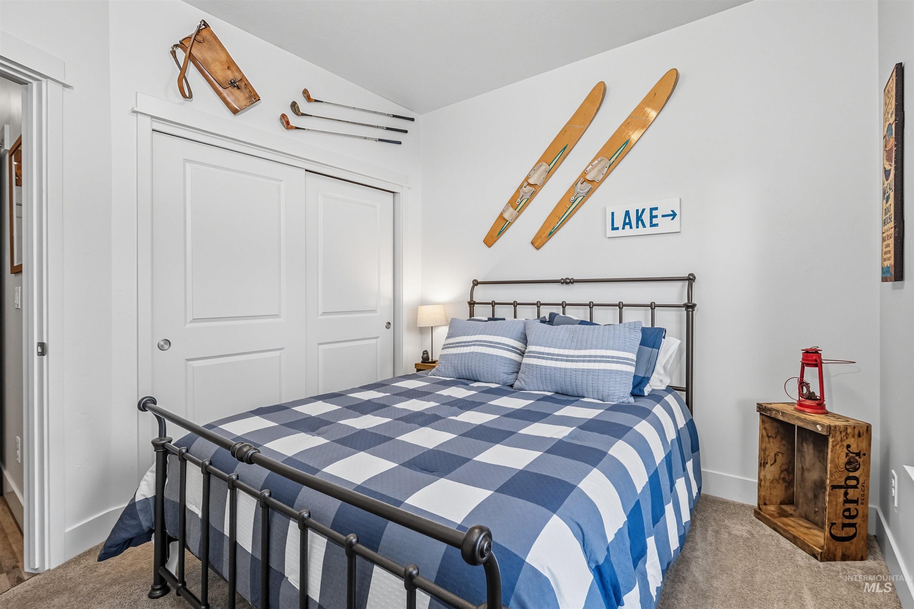 Carpeted bedroom with a closet and baseboards