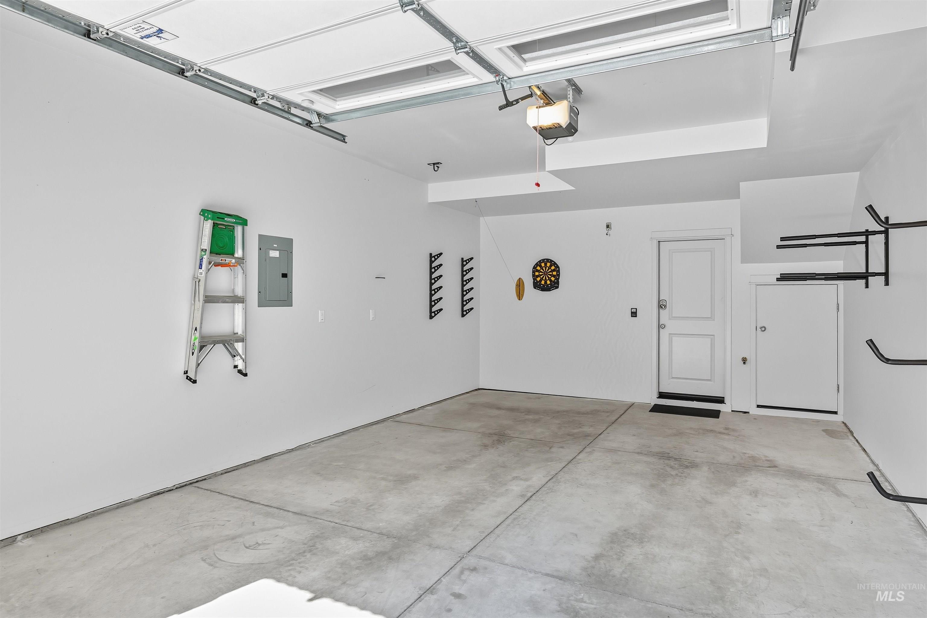 Garage with electric panel and a garage door opener