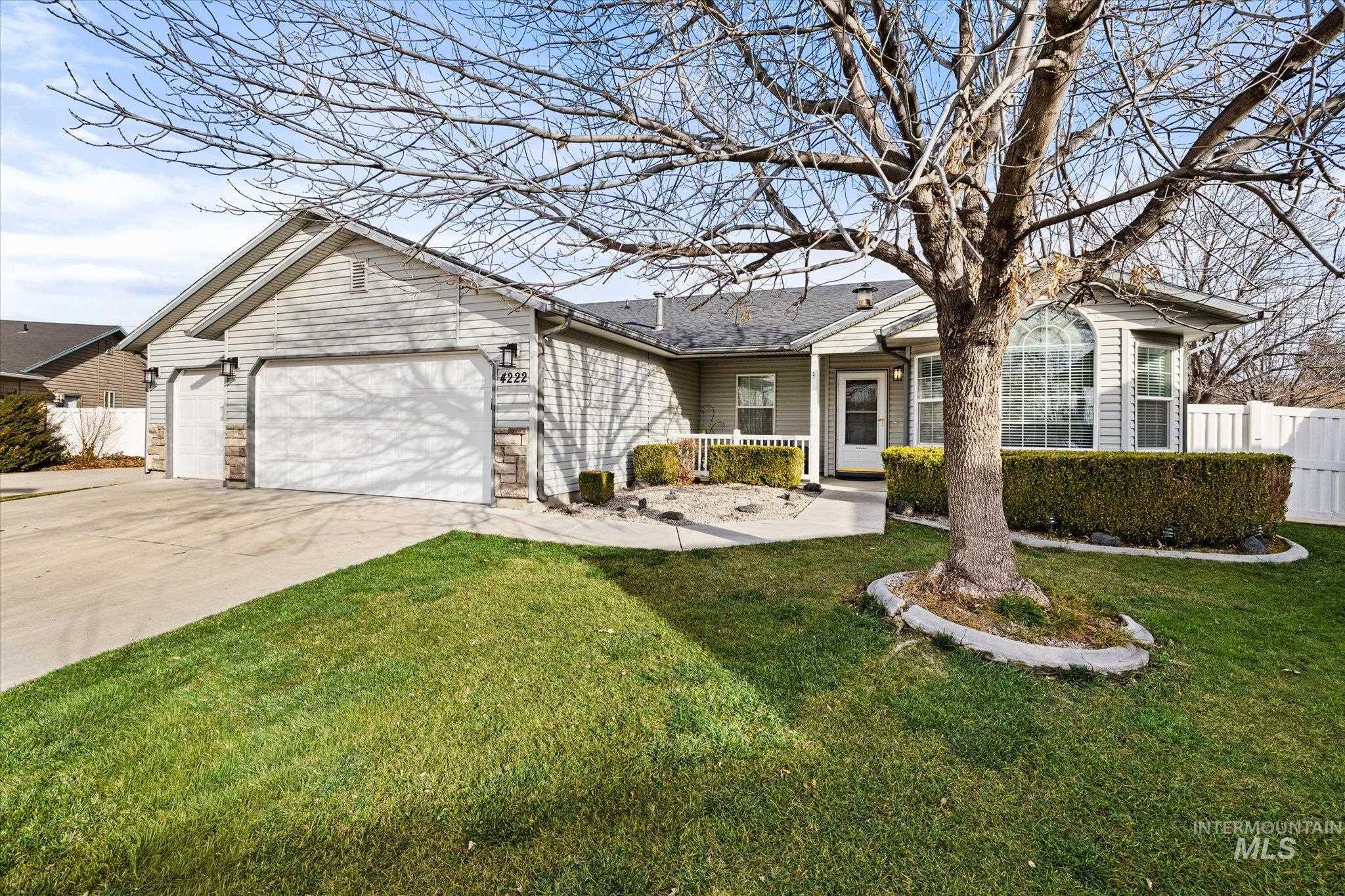 Ranch-style house featuring concrete driveway and a garage