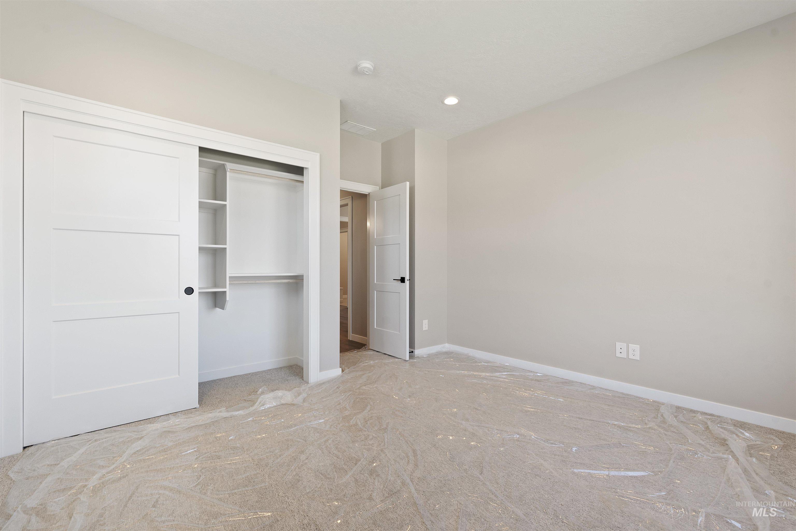 Unfurnished bedroom with a closet and recessed lighting