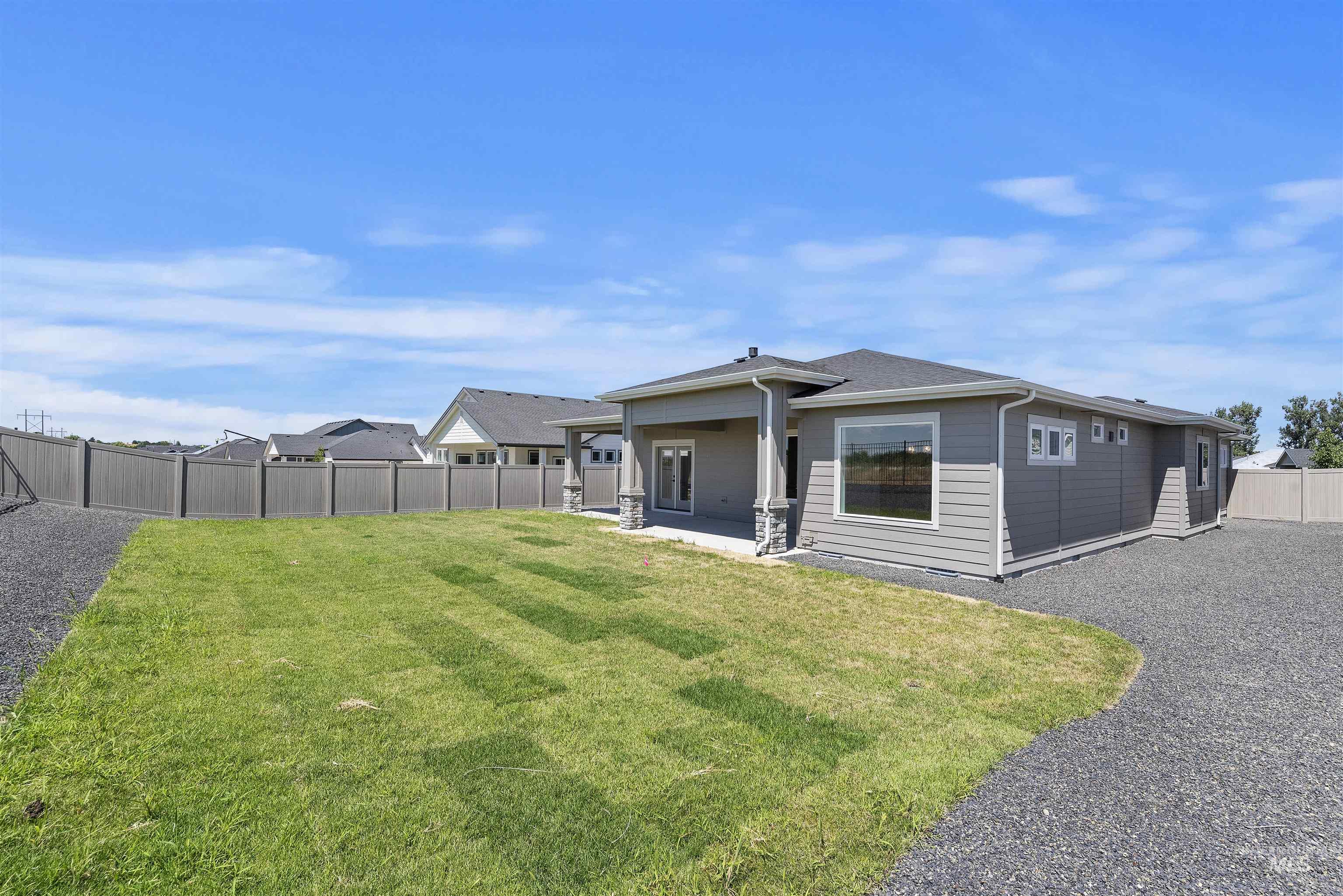 Back of house with a fenced backyard and a patio area