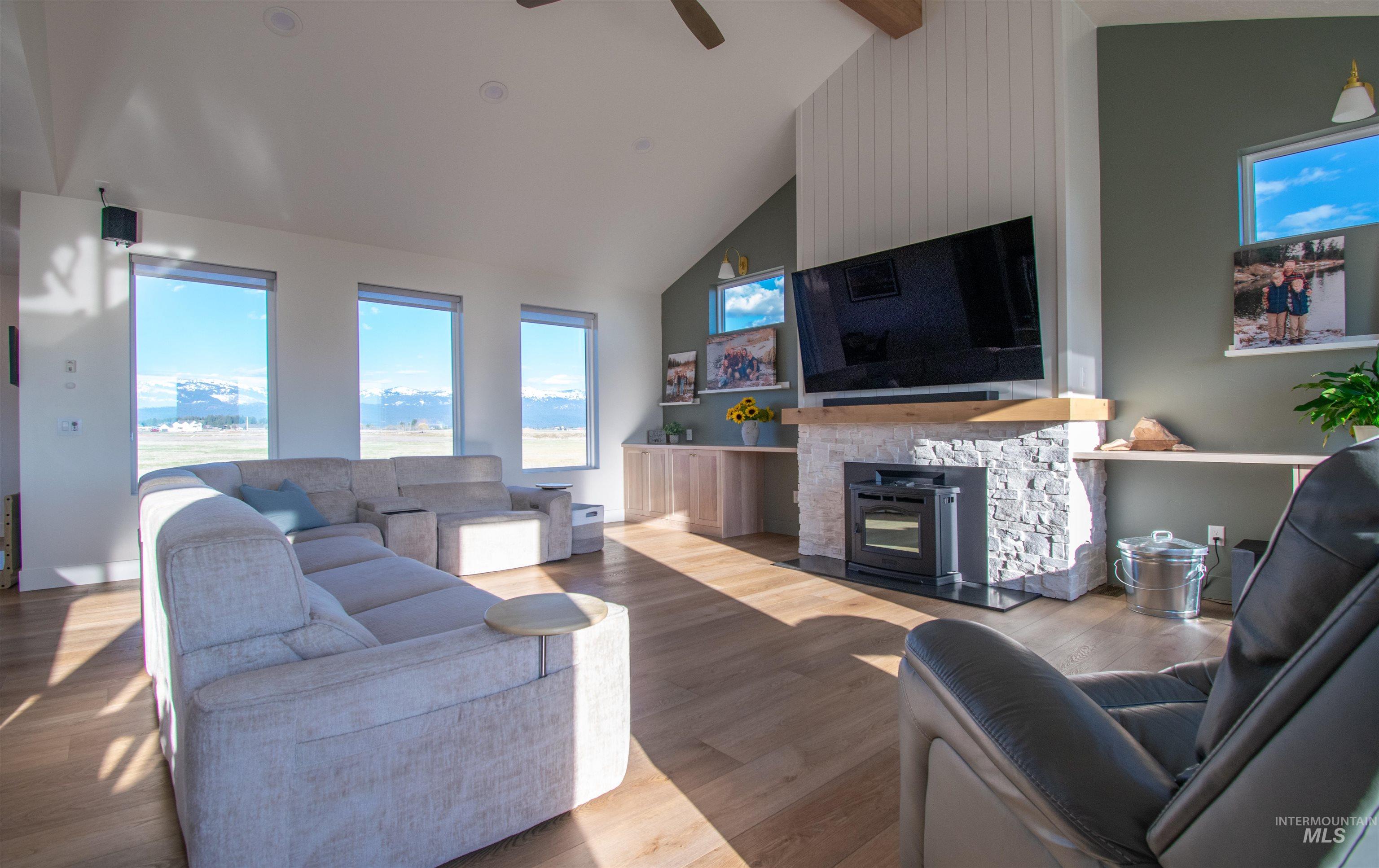 Vaulted ceiling living space with wood-finish flooring