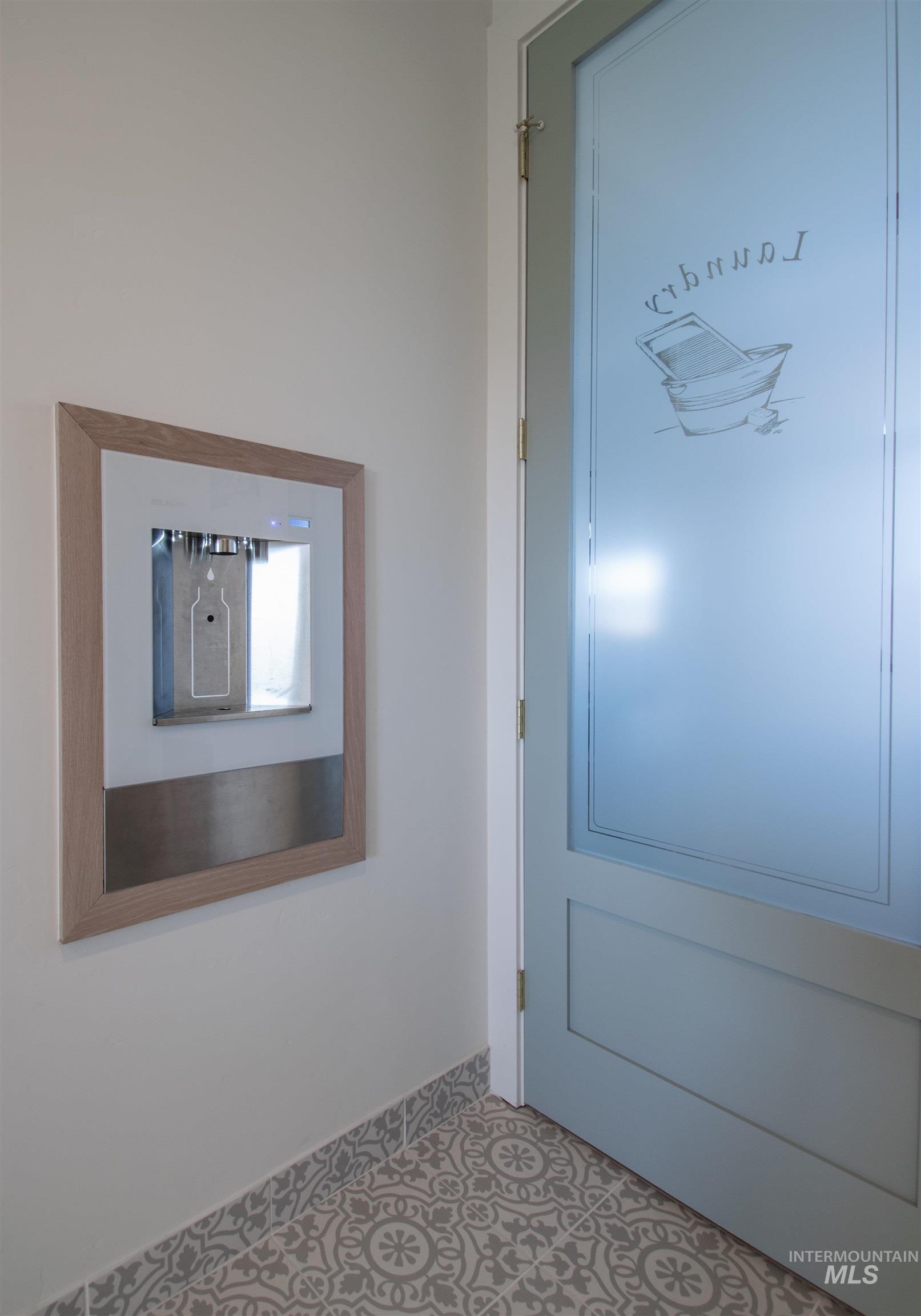 Built-in water dispenser with a light wood-finish frame