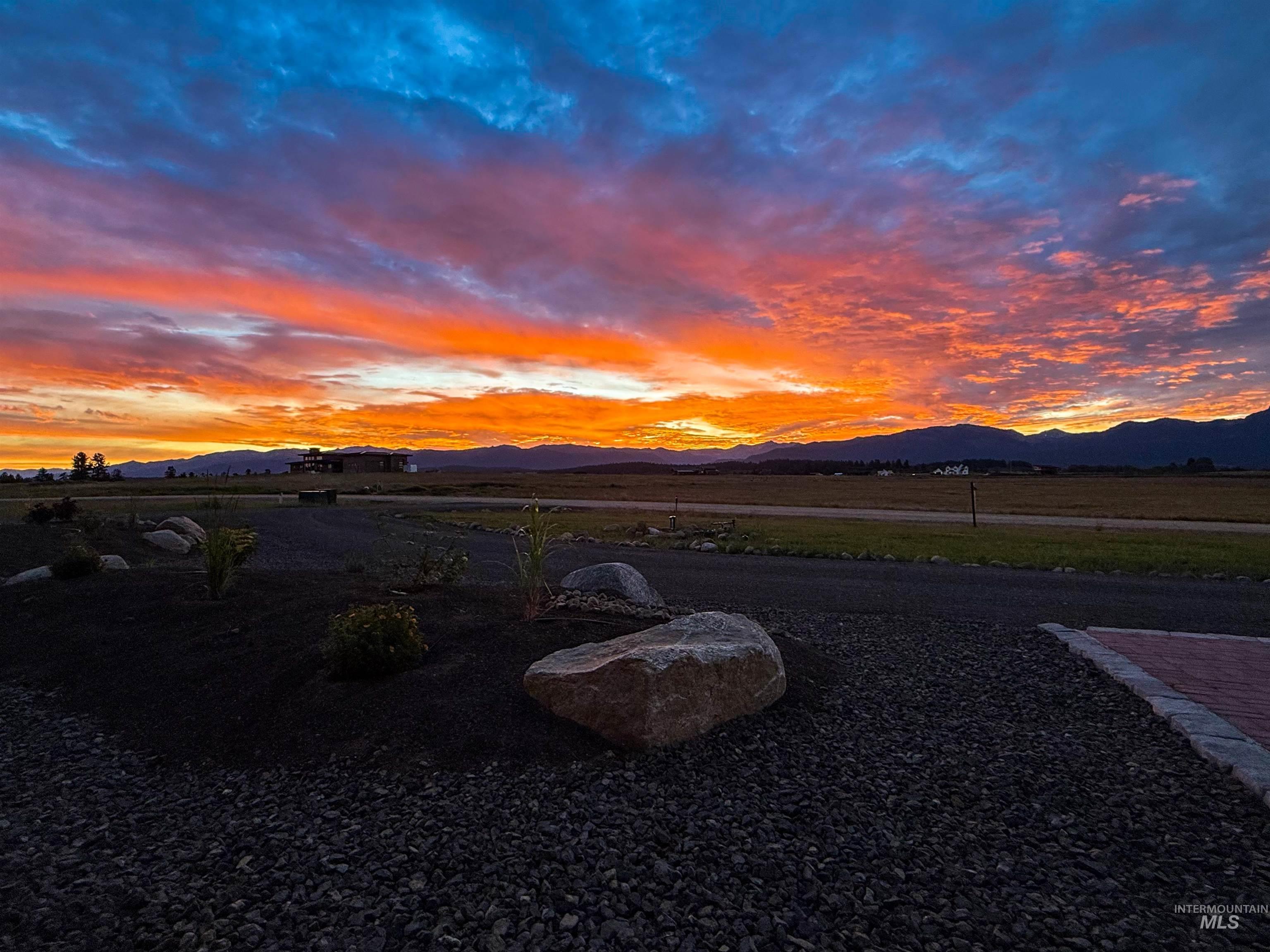 Expansive outdoor space featuring a decorative rock landscape, natural boulders, and cultivated plantings