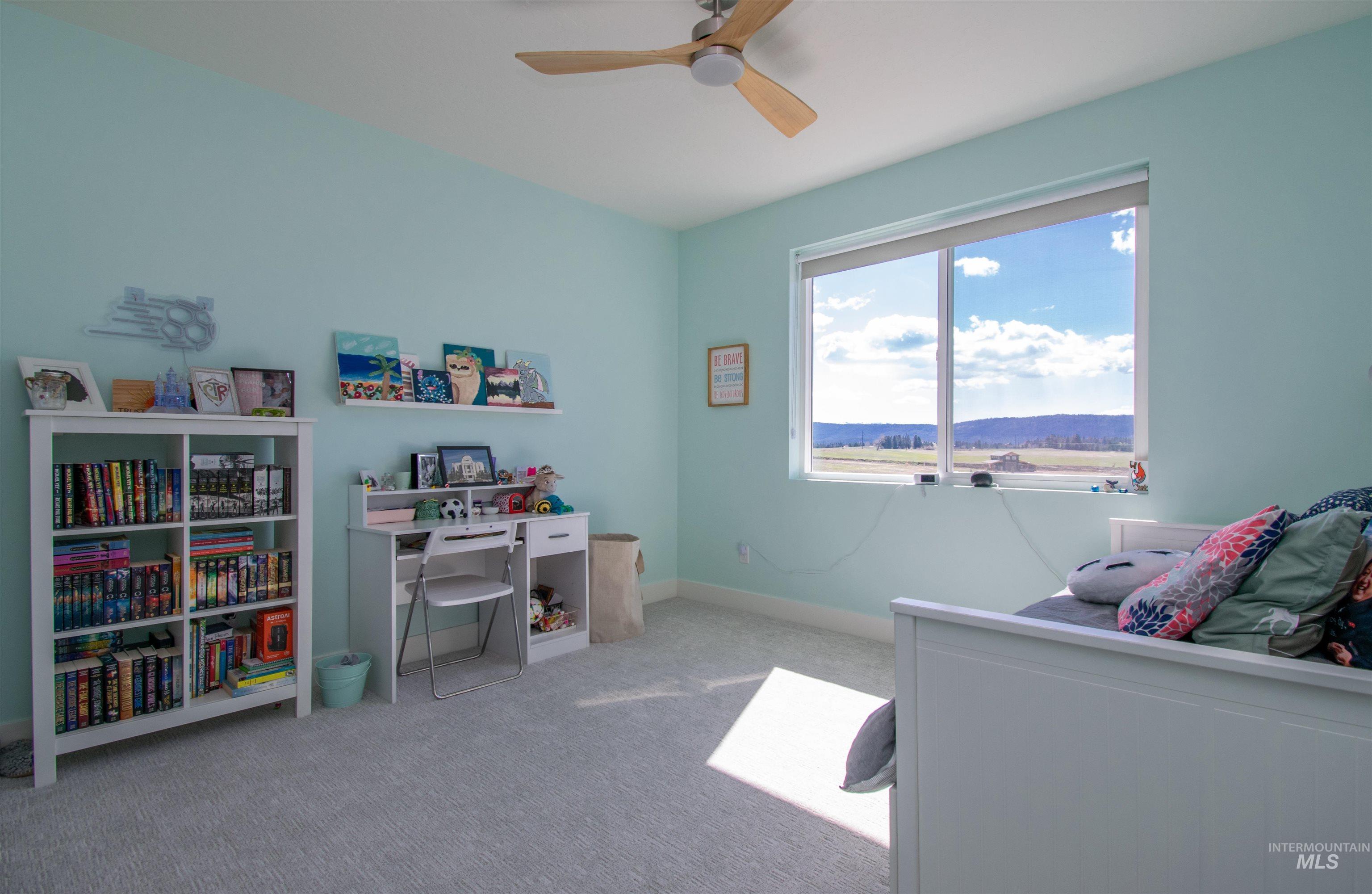 Room featuring light blue walls and neutral carpet flooring