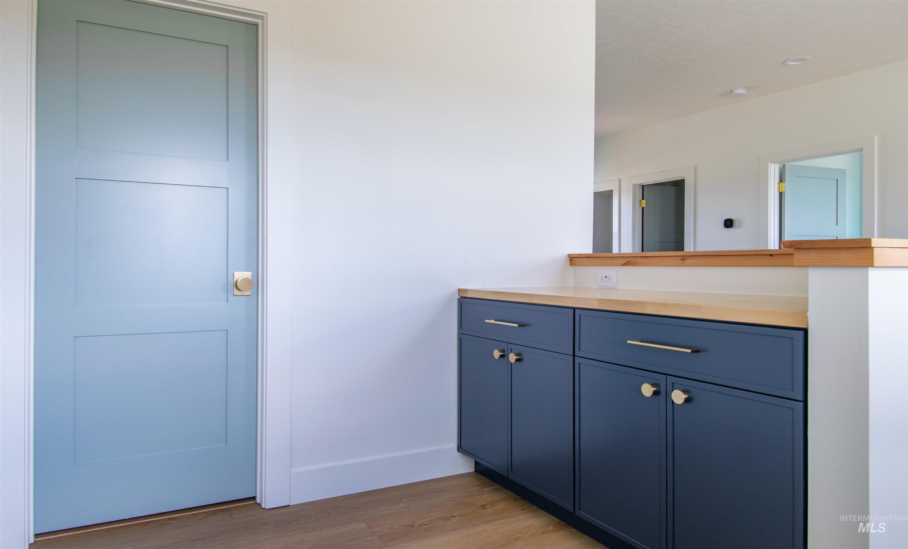 Blue three-panel interior door with a brass knob